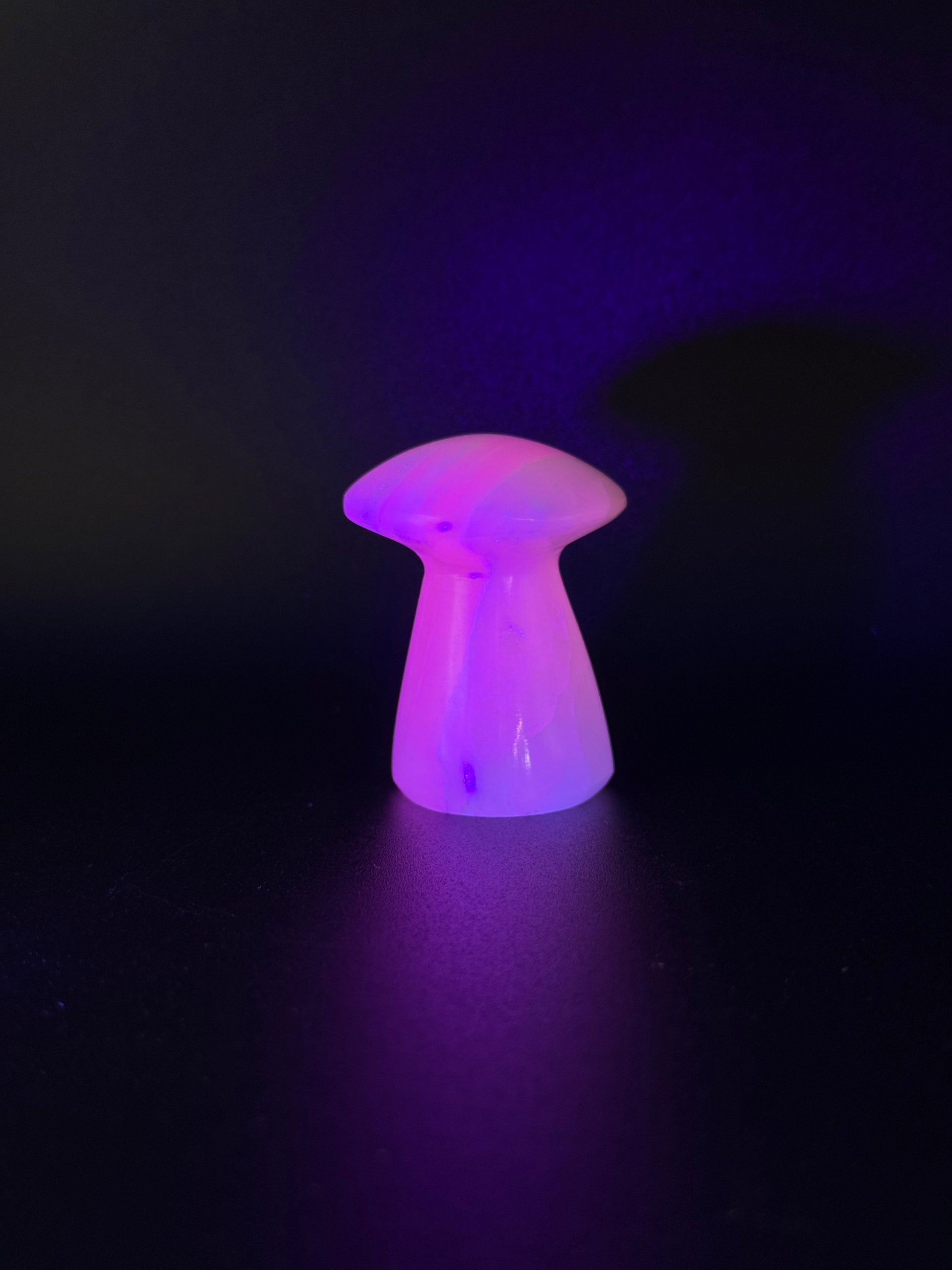 Polished pink calcite mushroom. Pink calcite glows under uv light.