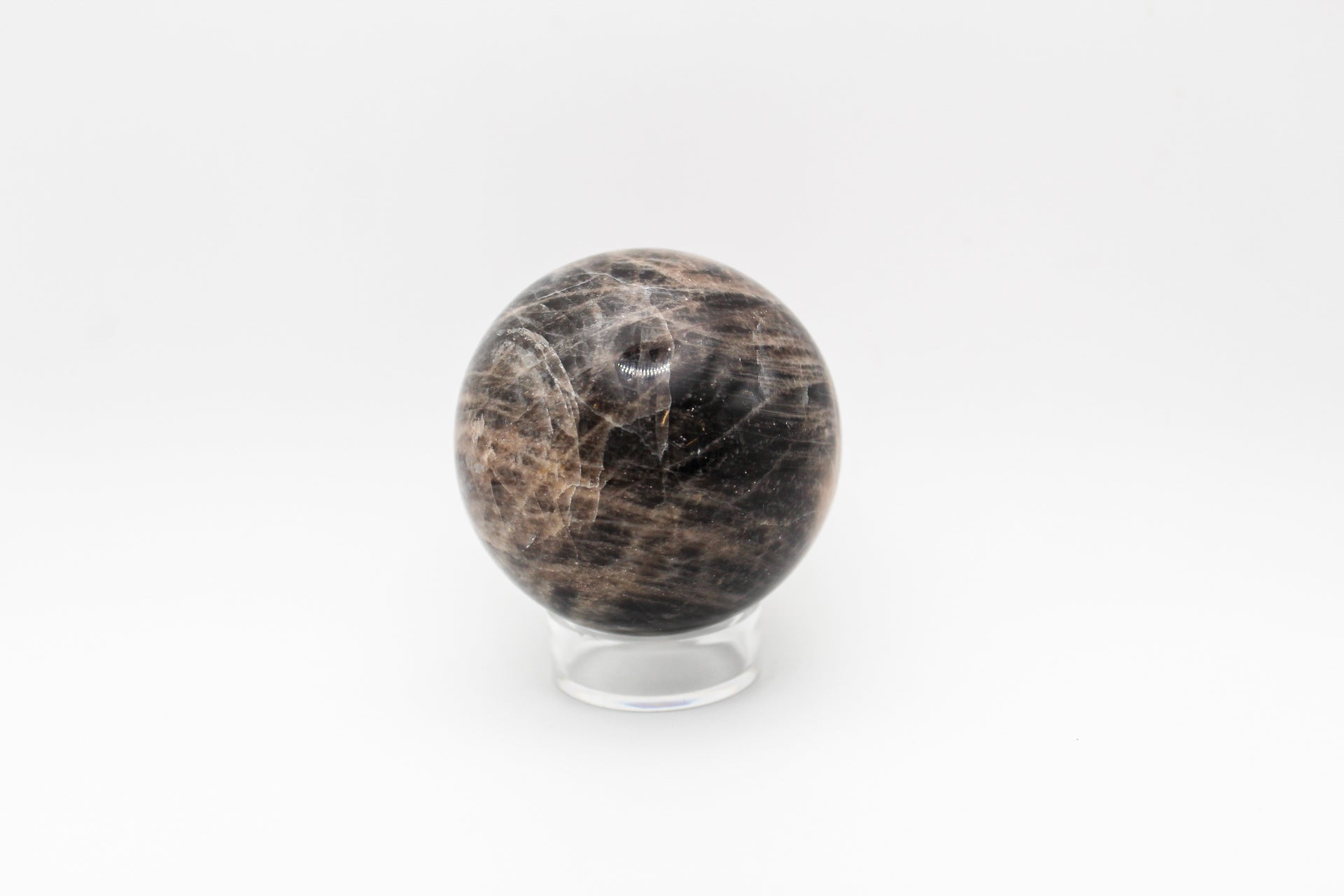 A polished black moonstone sphere.