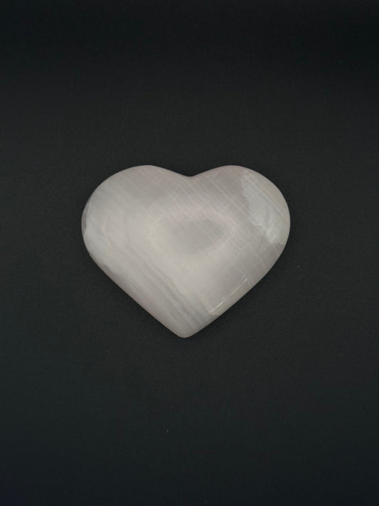 Polished Pink Calcite heart. Pink calcite is uv reactive.