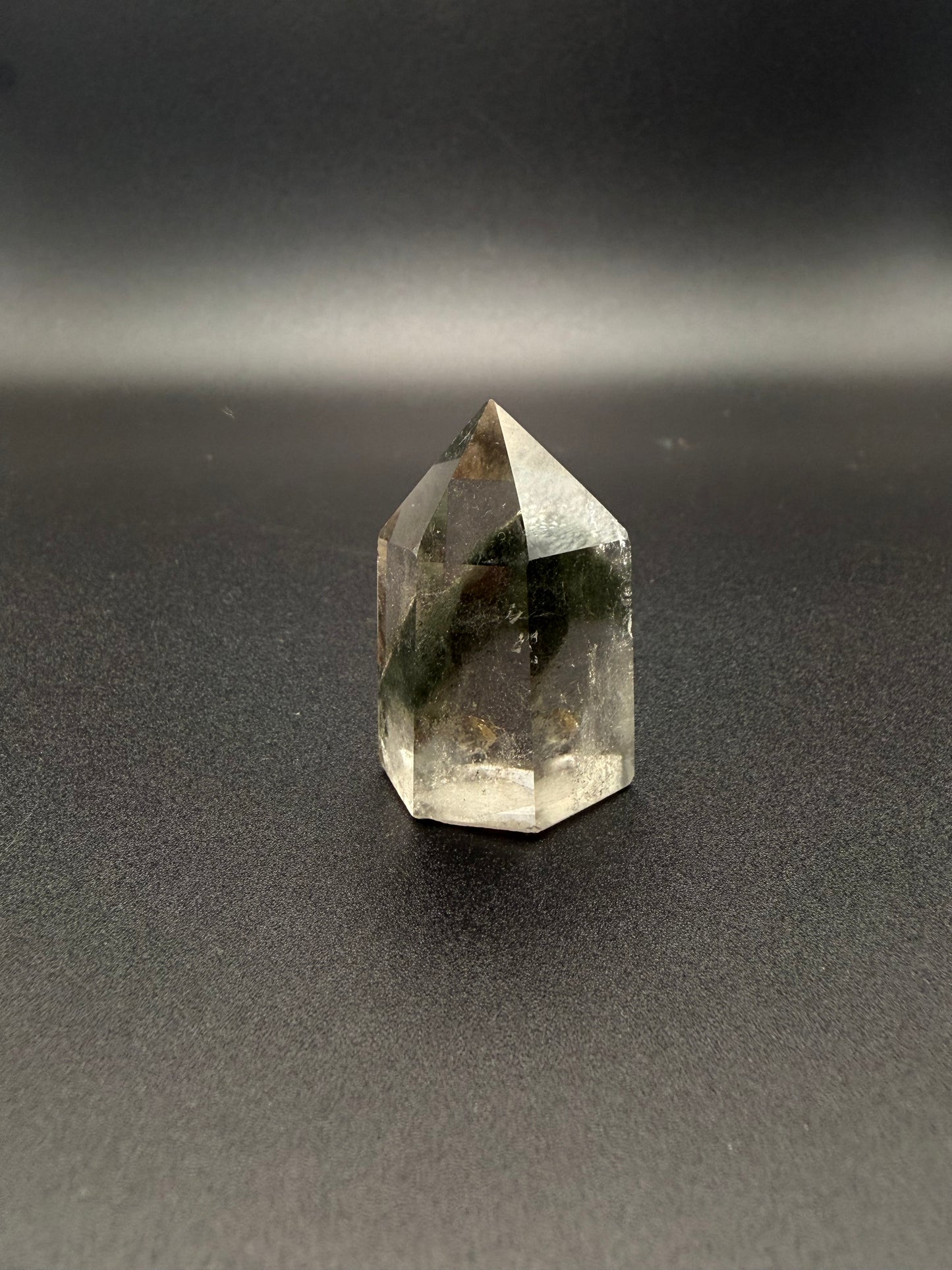 Polished garden quartz crystal tower with six sides.