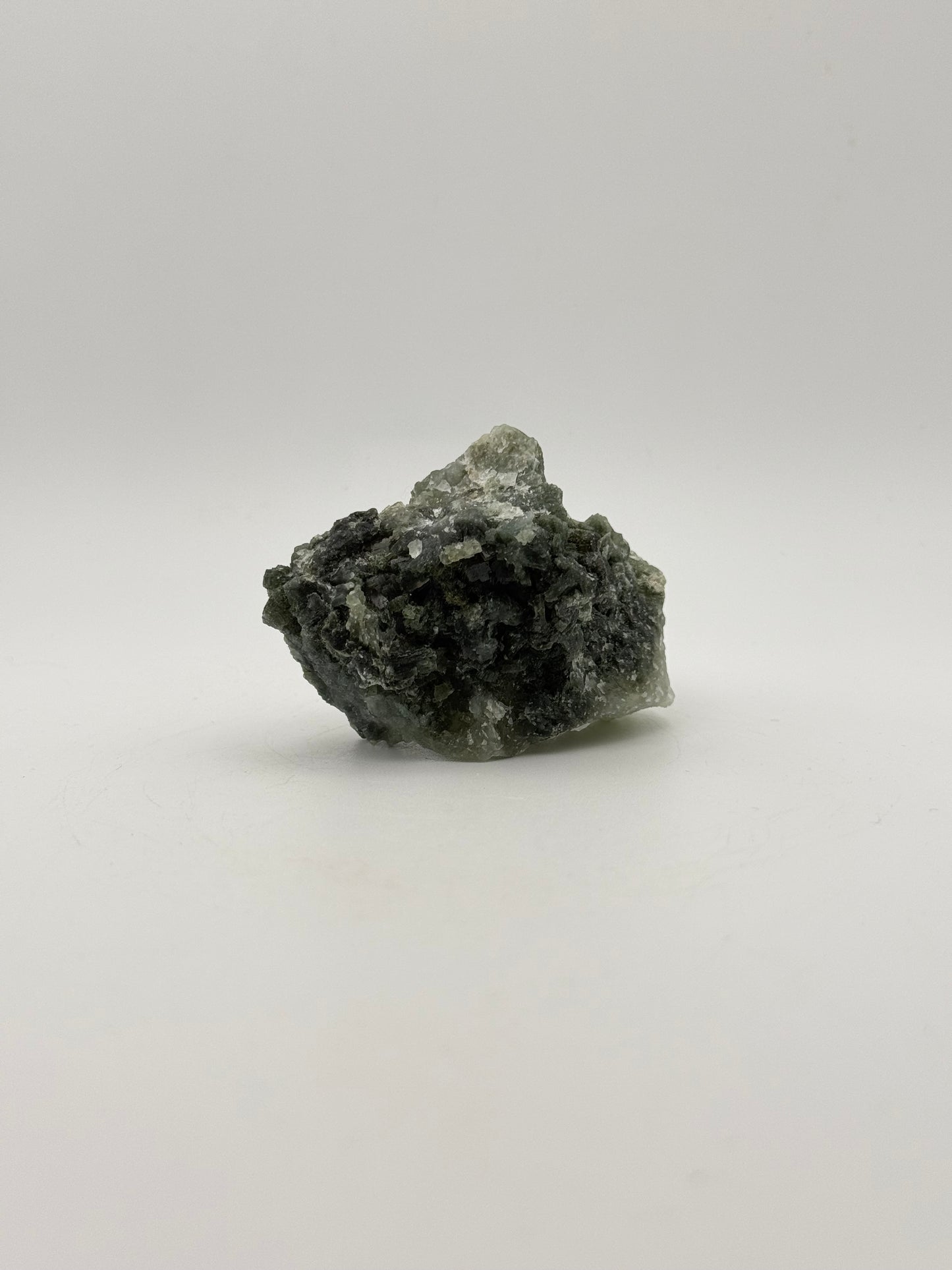 Raw prehnite specimen with good green coloring.