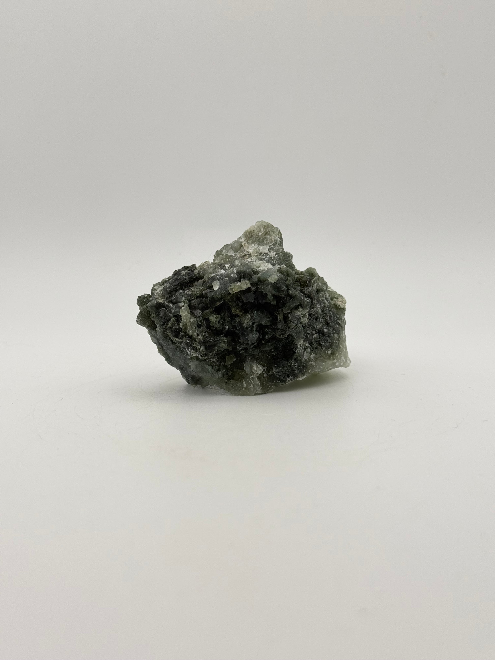 Raw prehnite specimen with good green coloring.