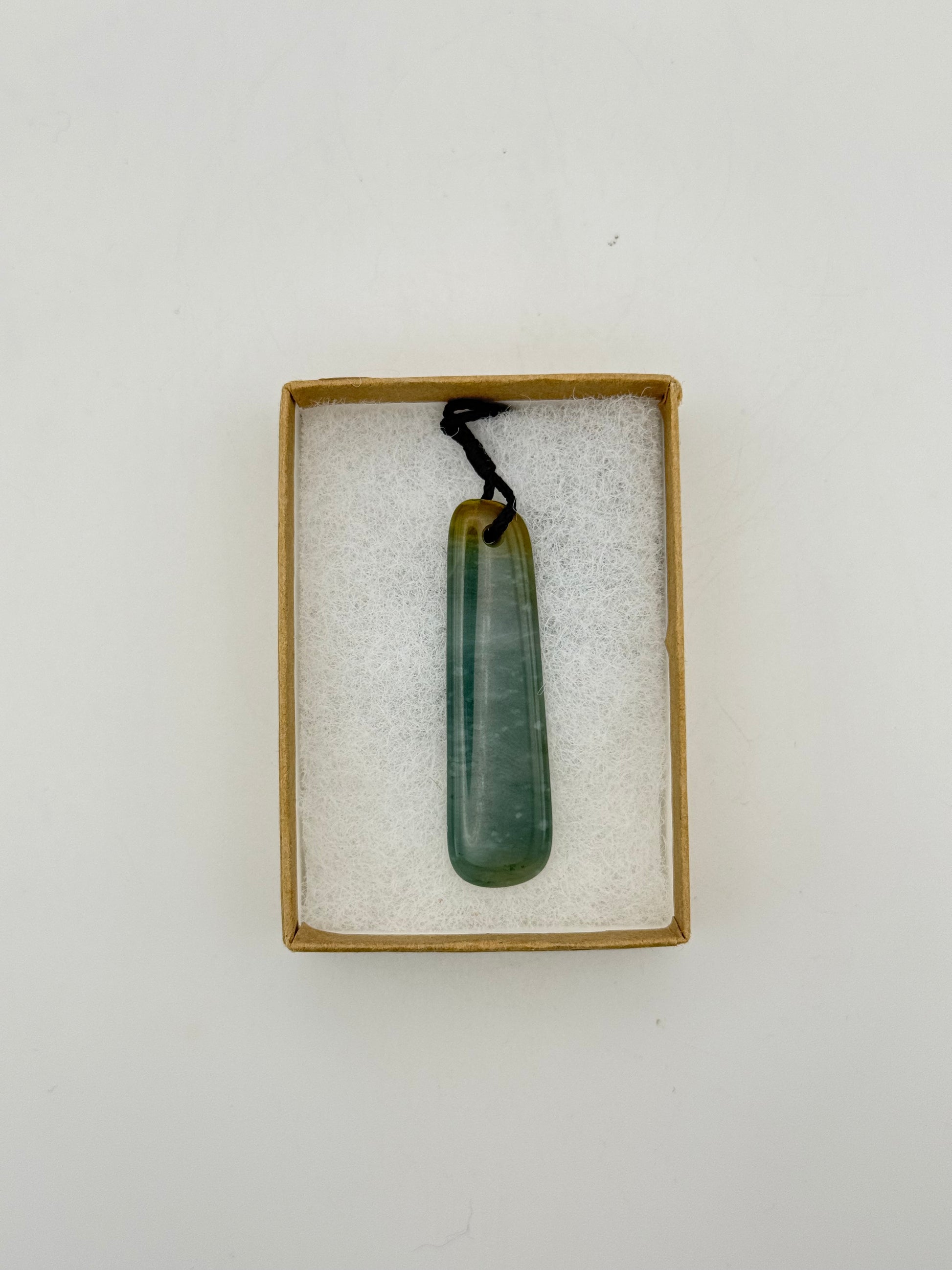 Green Jade pendant with string necklace.