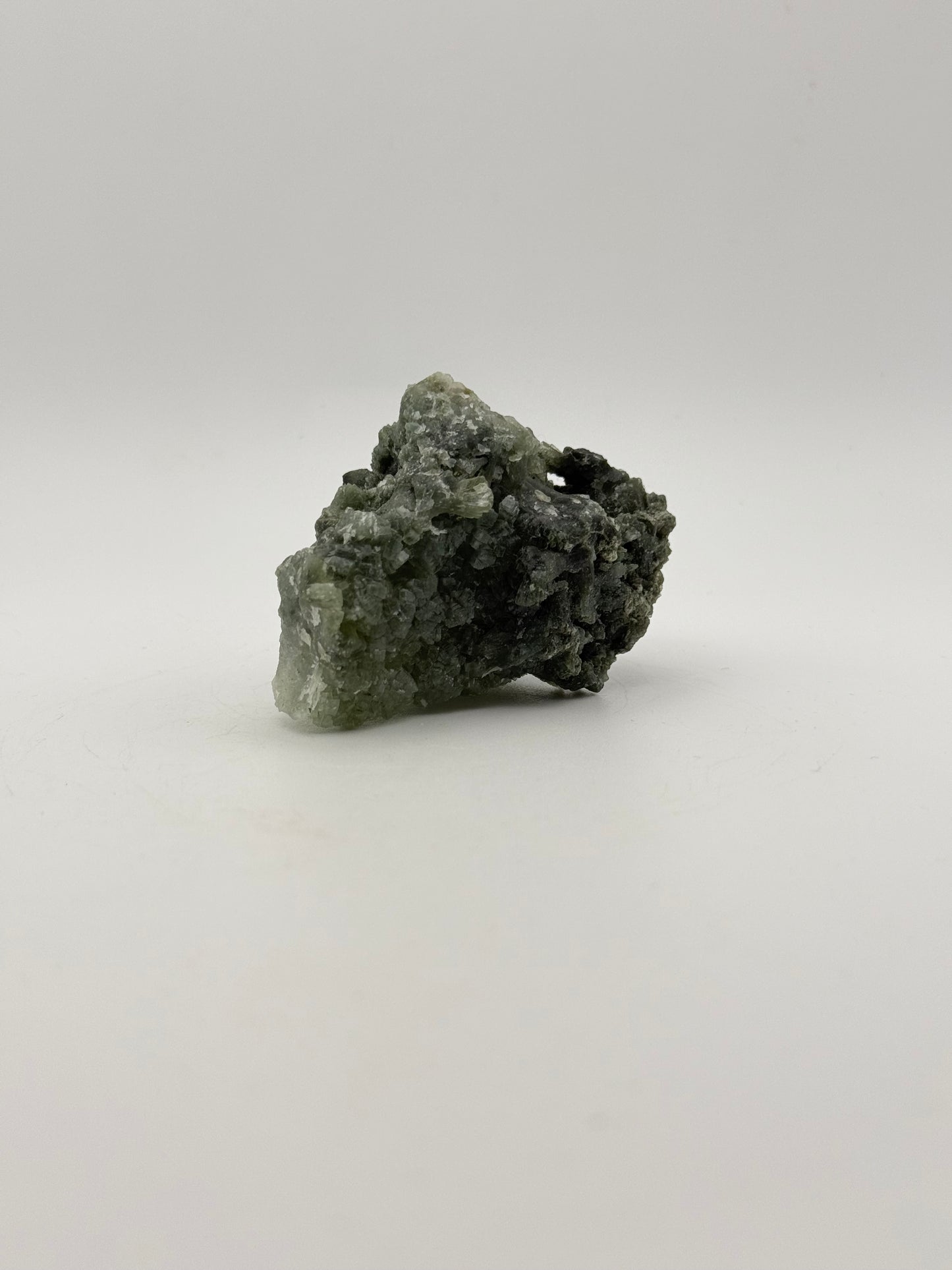 Raw prehnite specimen with good green coloring.