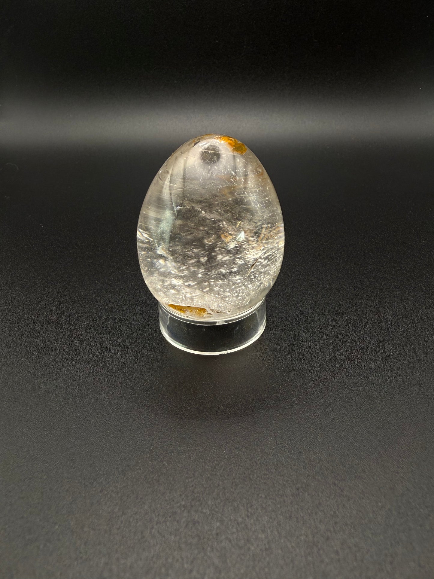 Clear quartz polished crystal thats egg shaped.