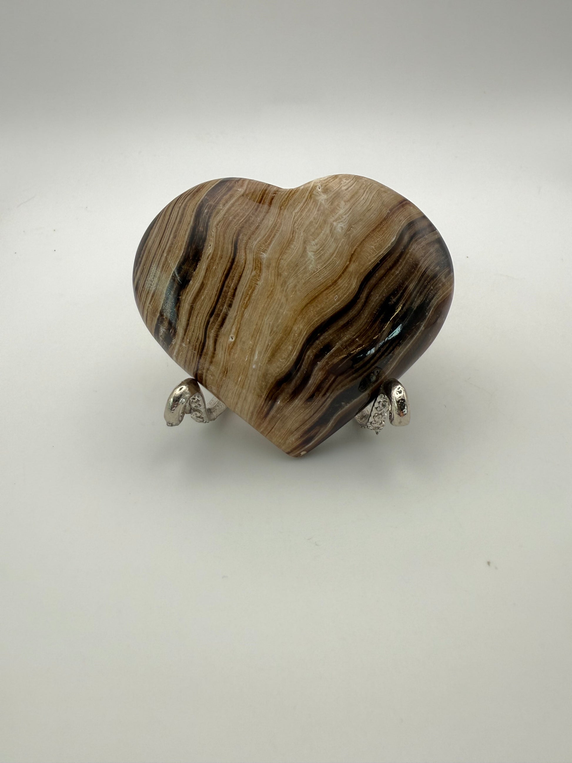 Polished chocolate calcite heart shaped crystal.