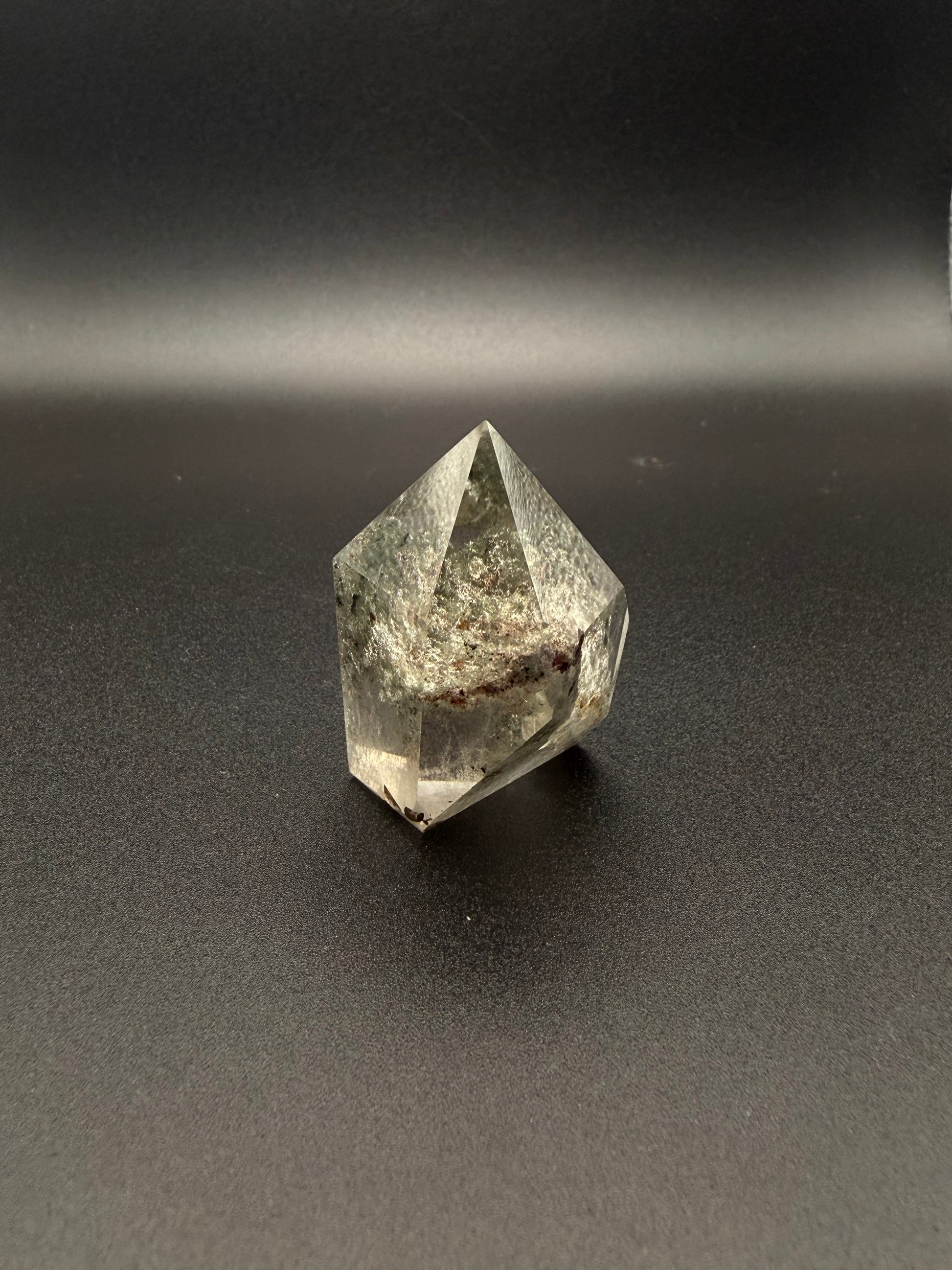 Polished garden quartz crystal tower with six sides.