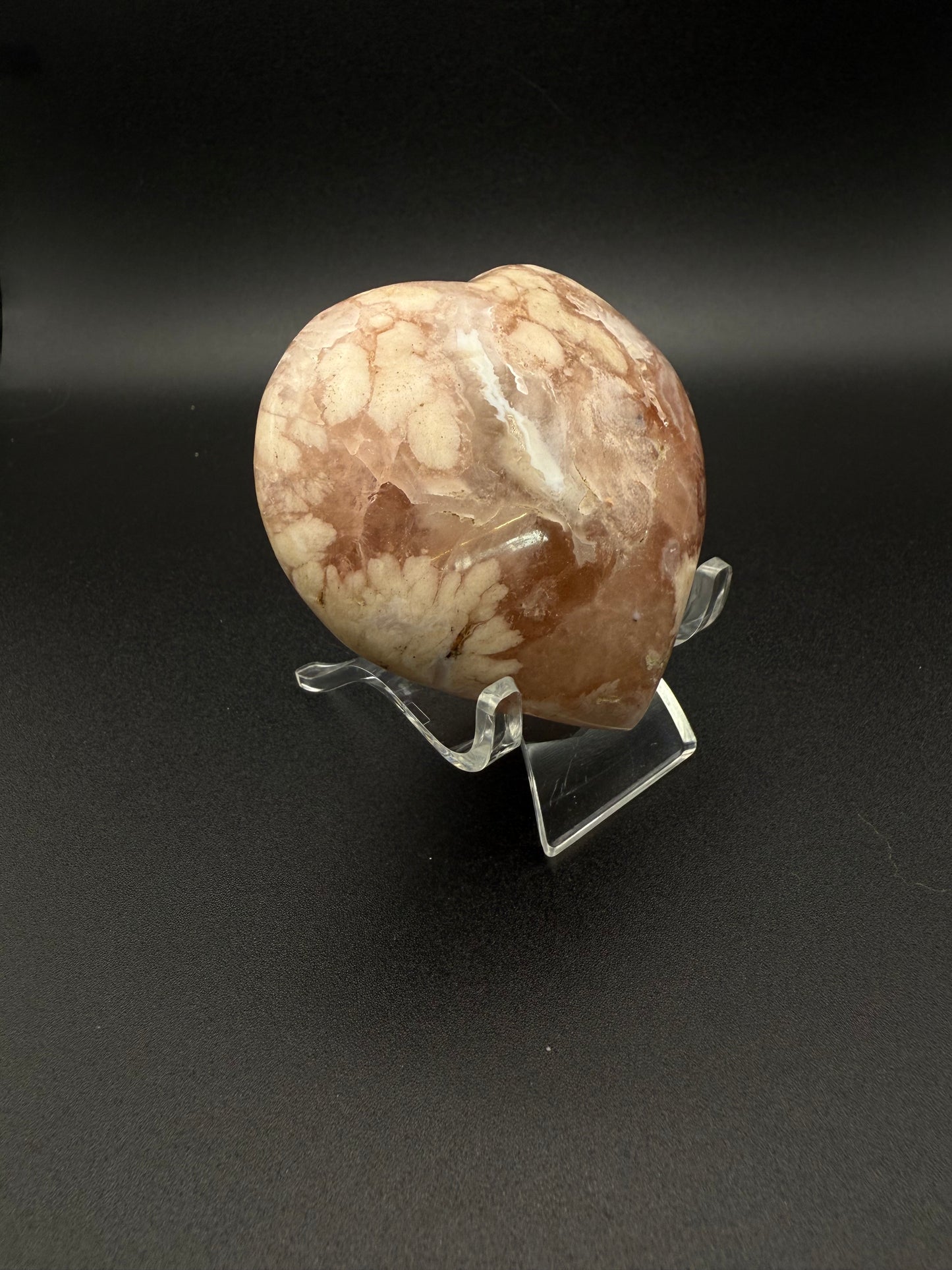 Flower agate polished crystal in the shape of a heart.