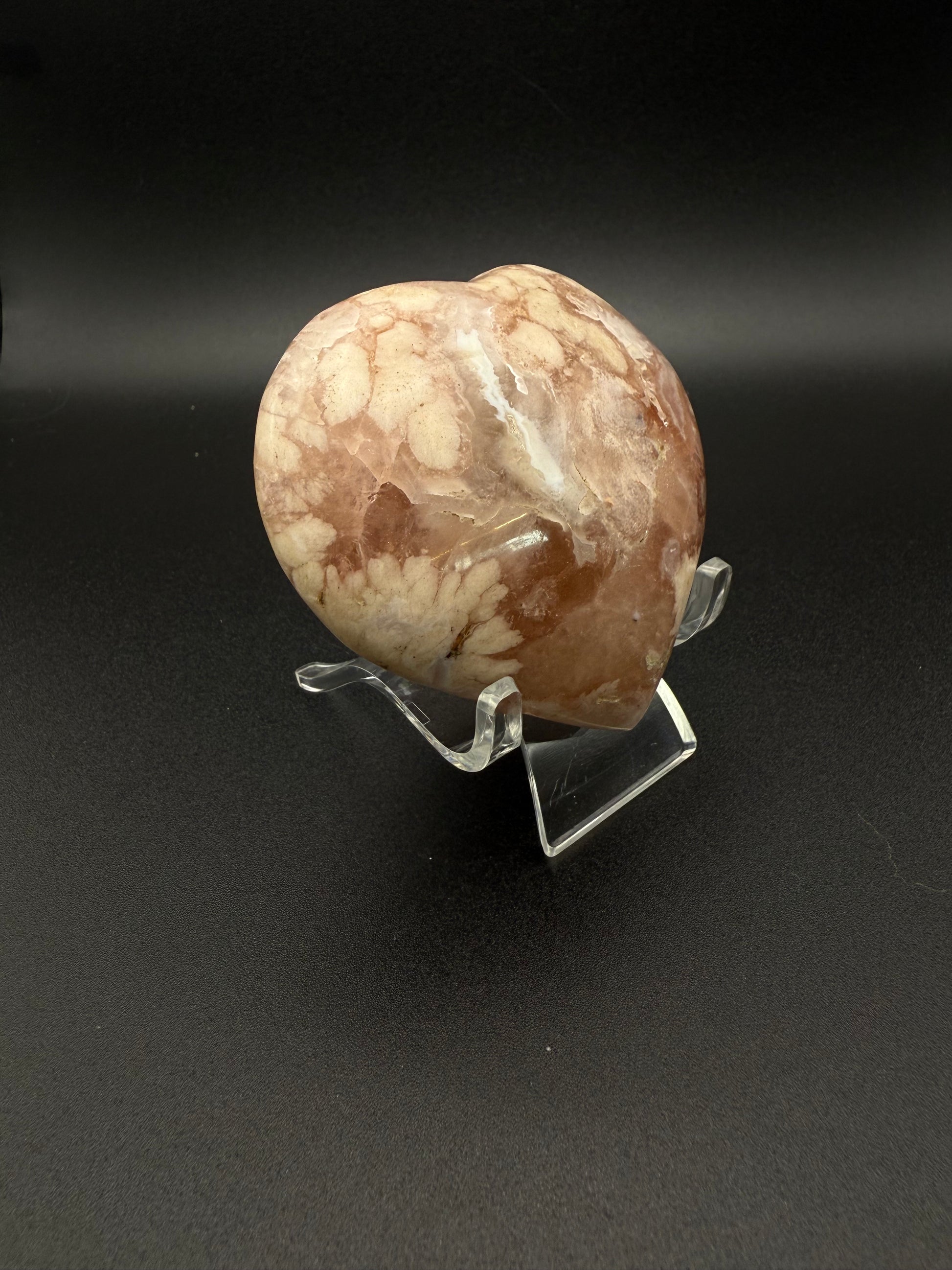 Flower agate polished crystal in the shape of a heart.
