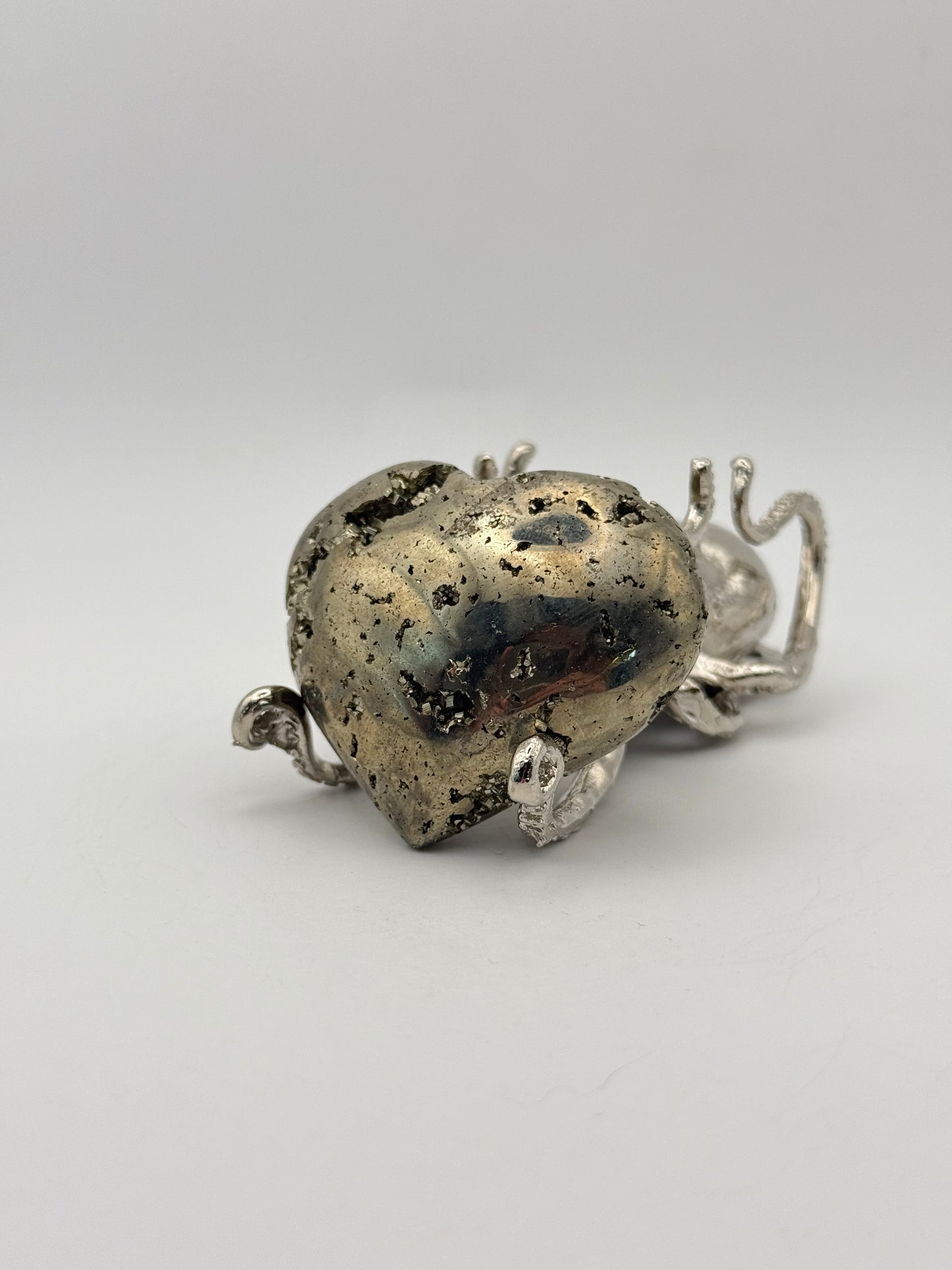 Polished pyrite crystal in the shape of a heart.