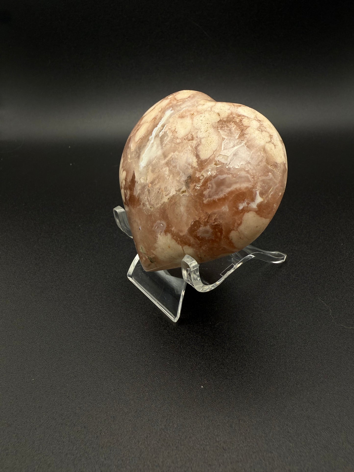 Flower agate polished crystal in the shape of a heart.