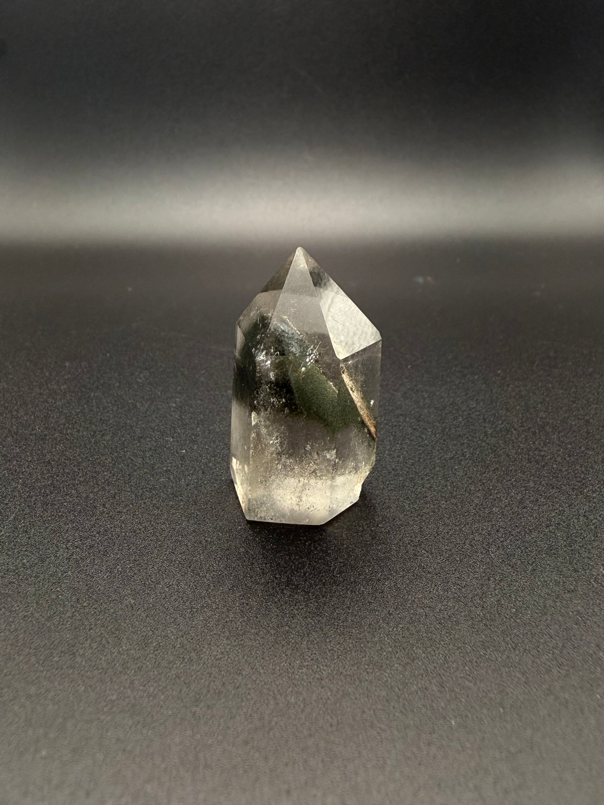 Polished garden quartz crystal tower with six sides.