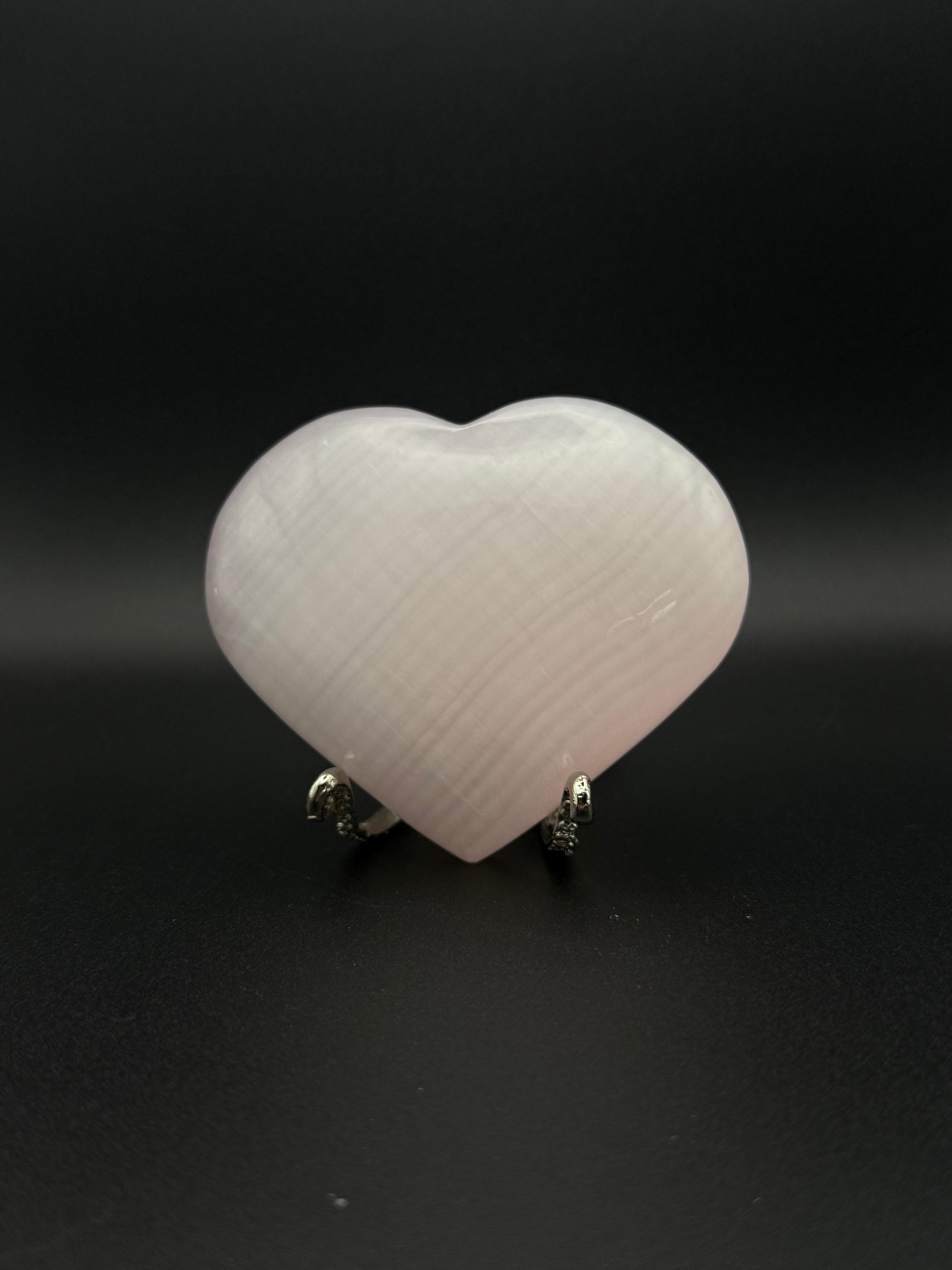 Polished pink calcite heart. Pink calcite glows under uv light.