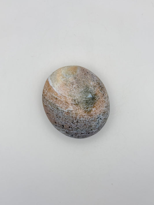 Polished ocean jasper palm stone.