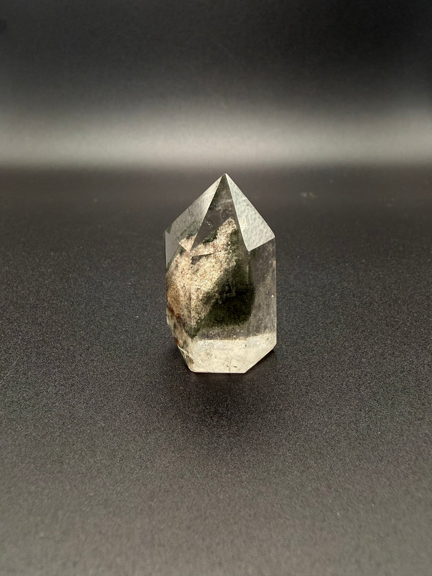 Polished garden quartz crystal tower with six sides.