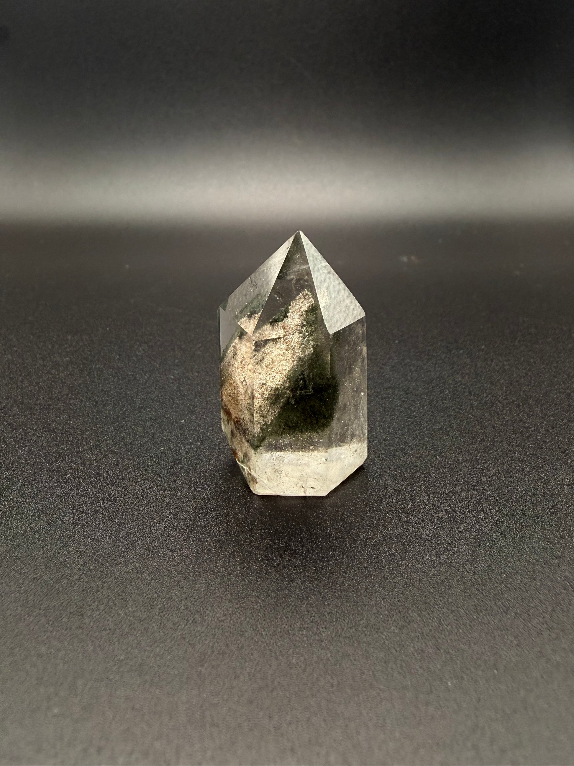 Polished garden quartz crystal tower with six sides.