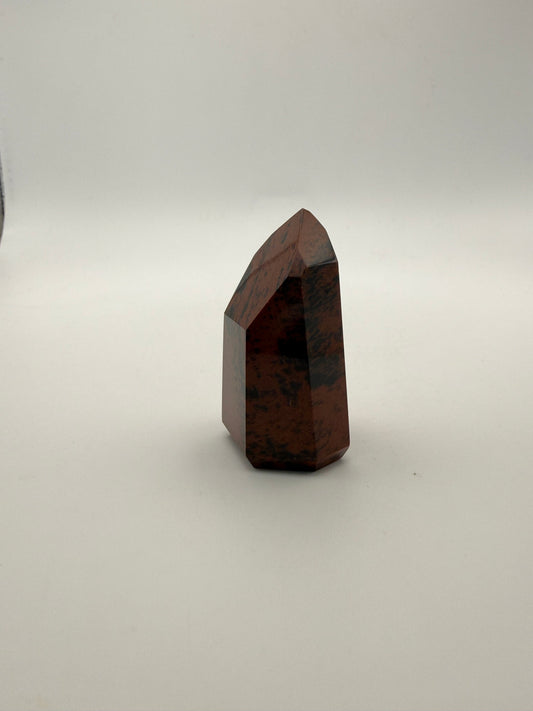 Polished mahogany obsidian tower with six sides.