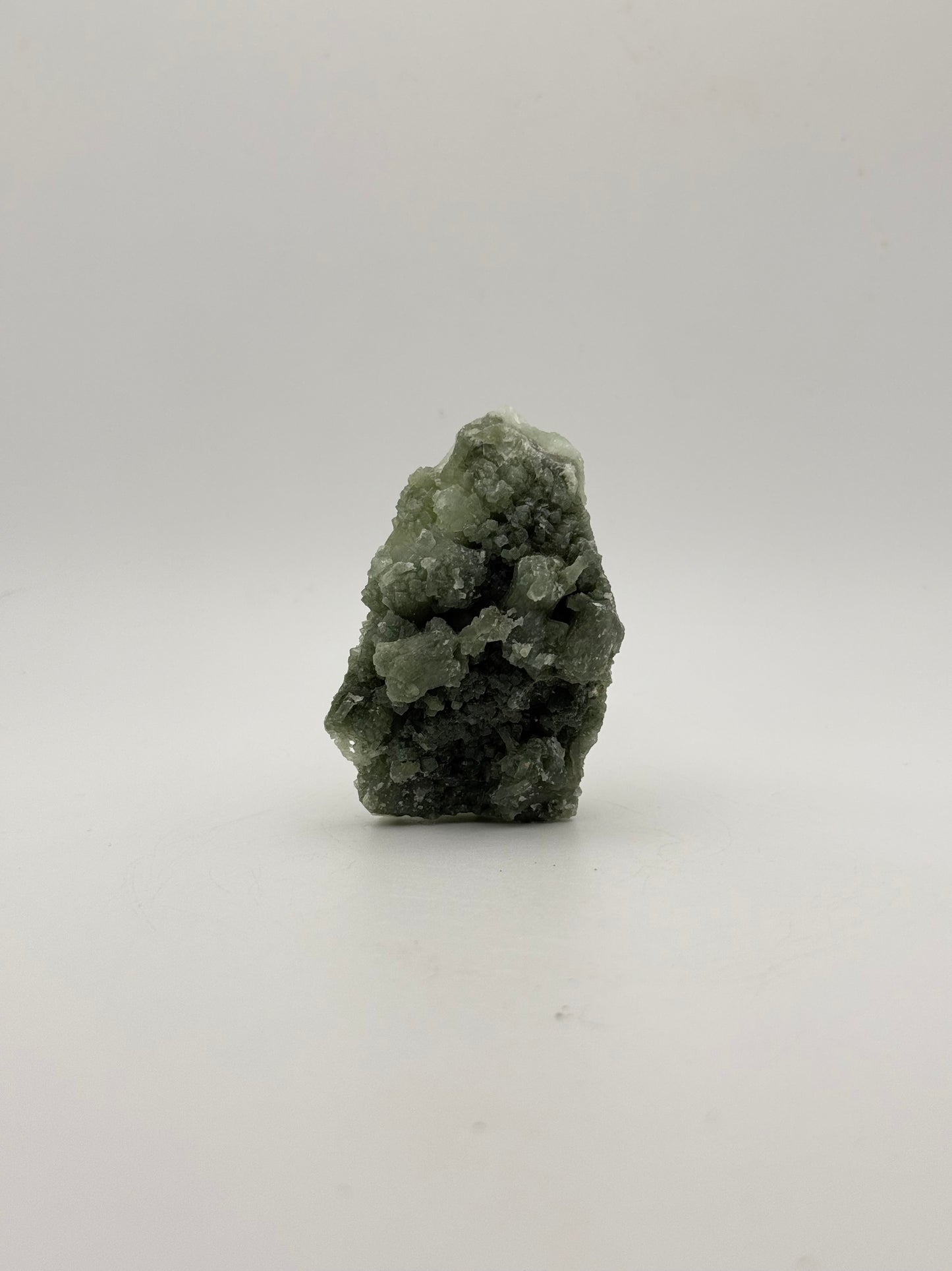Raw Prehnite specimen with amazing green color.