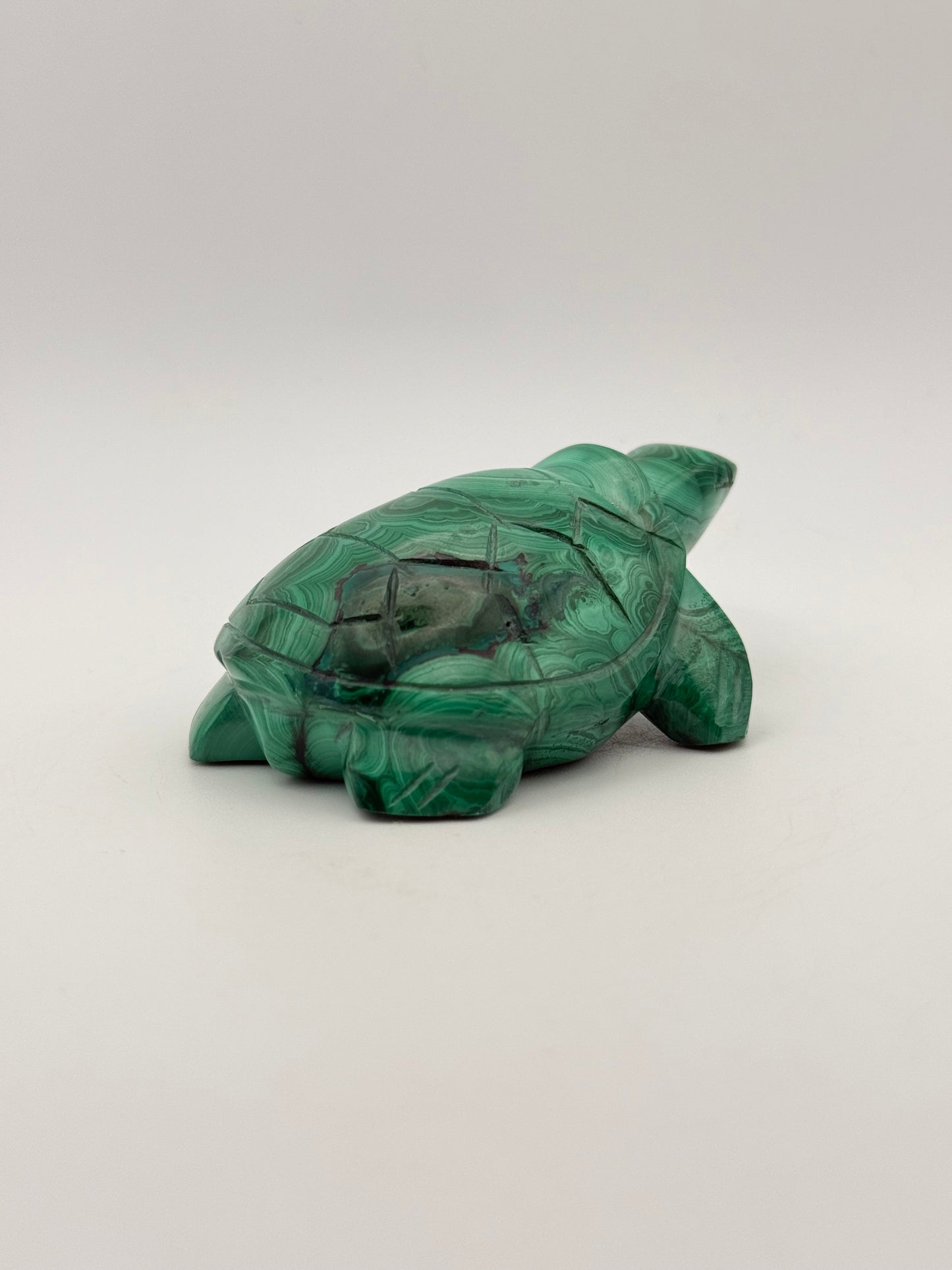 Vibrant green malachite stone carving of a turtle.
