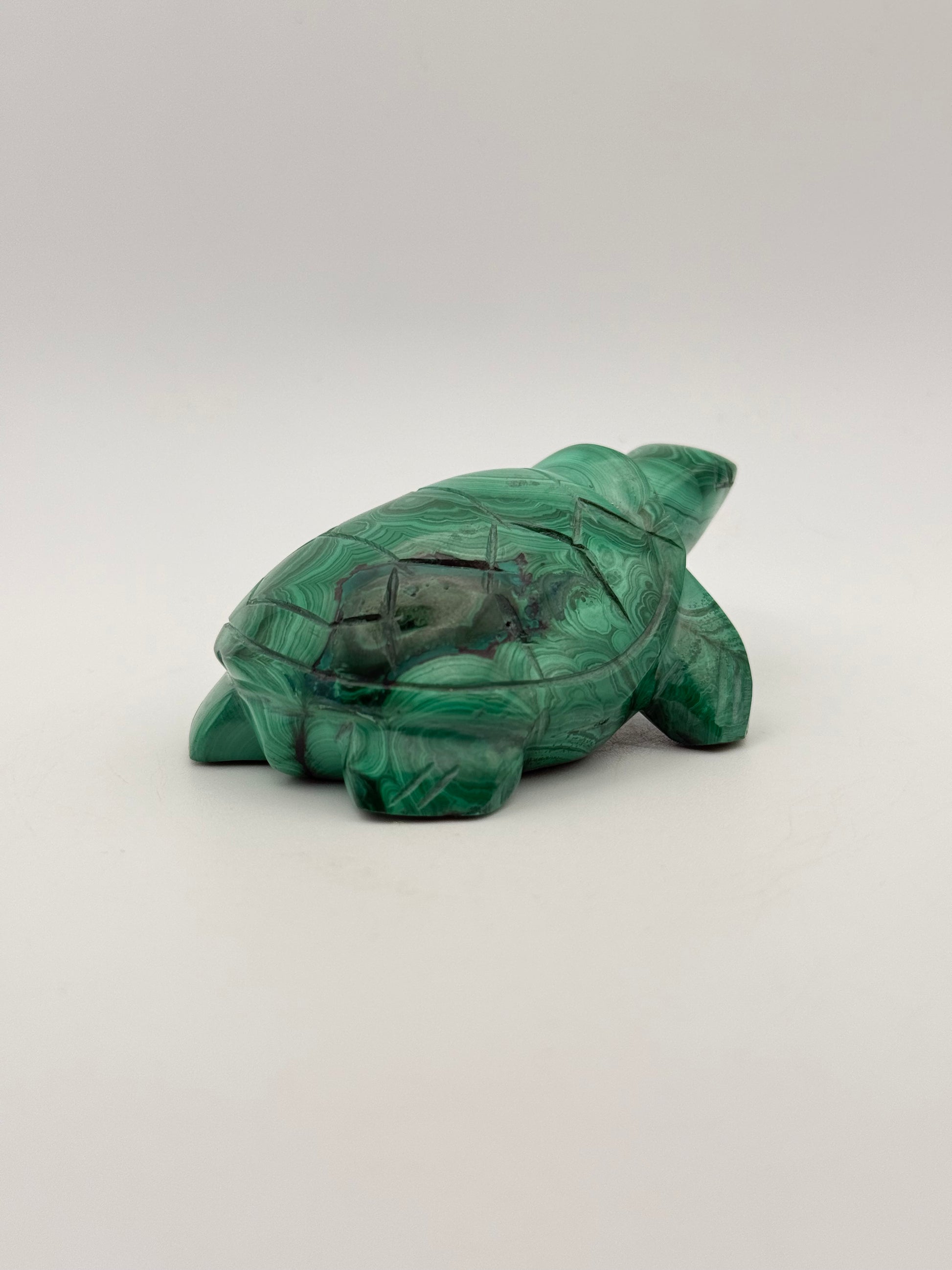 Vibrant green malachite stone carving of a turtle.