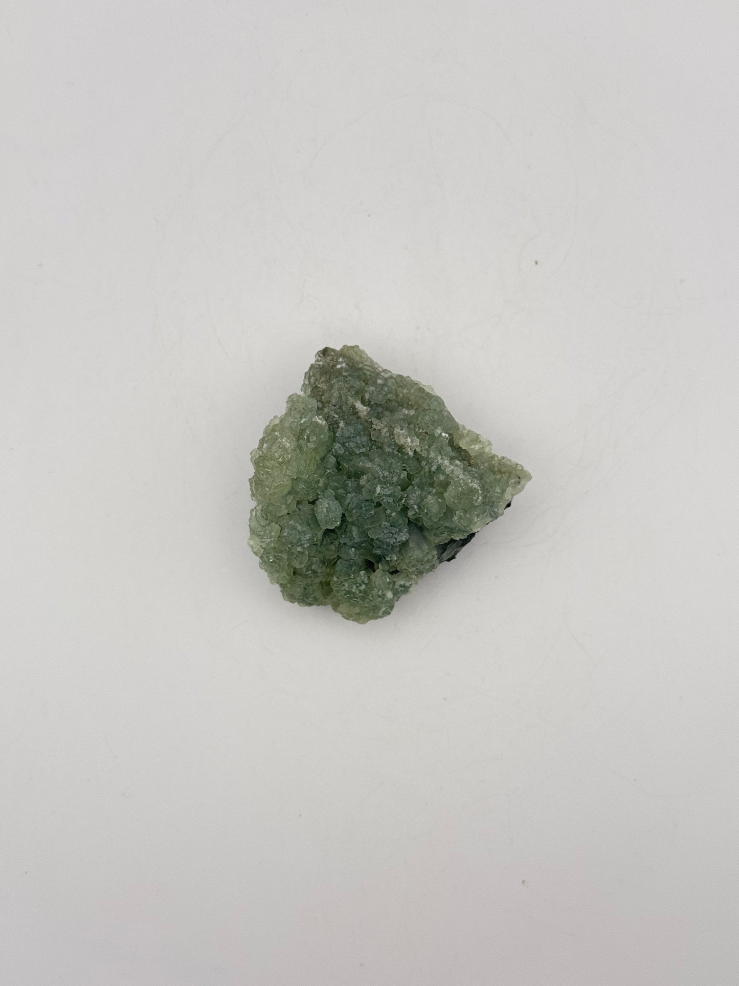 Raw Prehnite specimen with amazing green color.