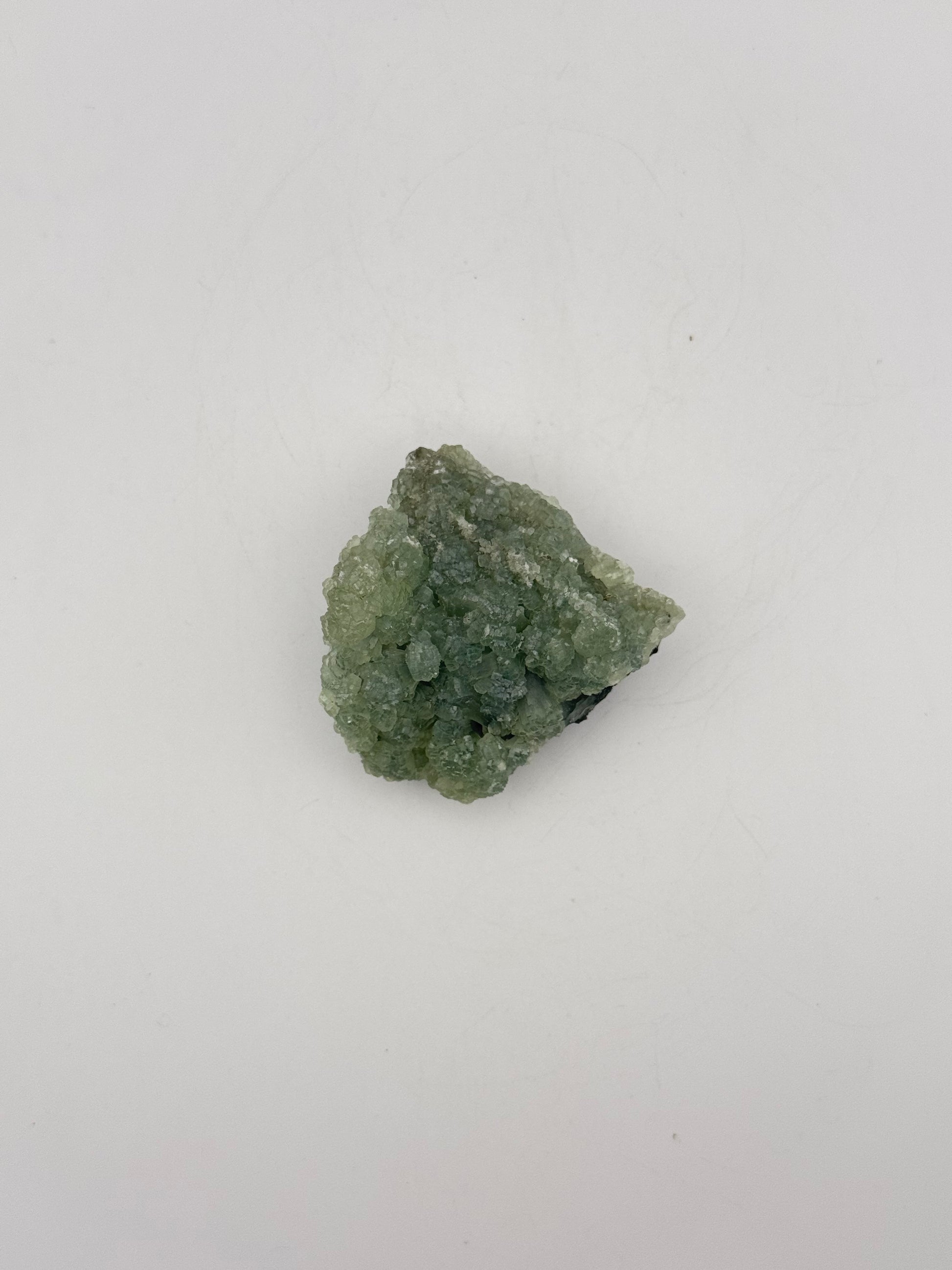 Raw Prehnite specimen with amazing green color.