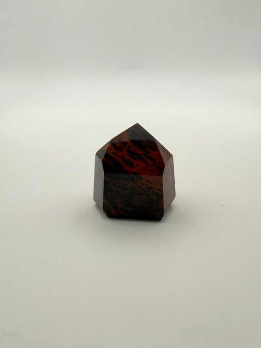 Polished mahogany obsidian tower with six sides.