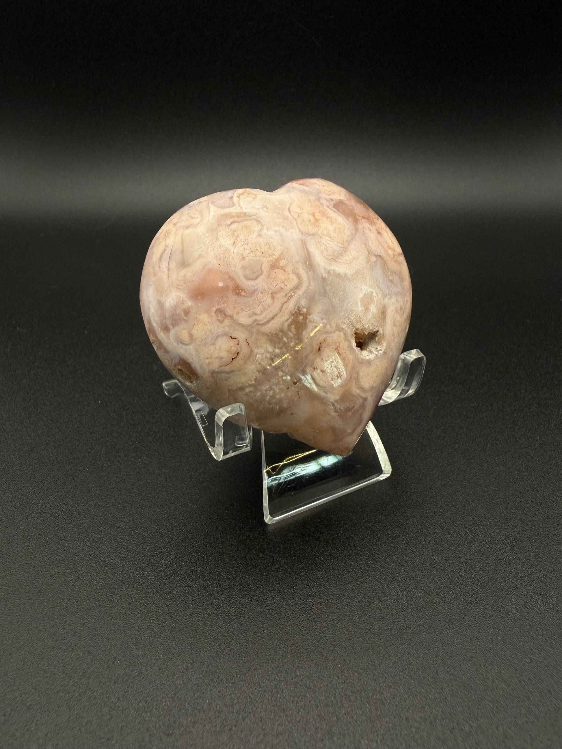 Flower agate polished crystal in the shape of a heart.