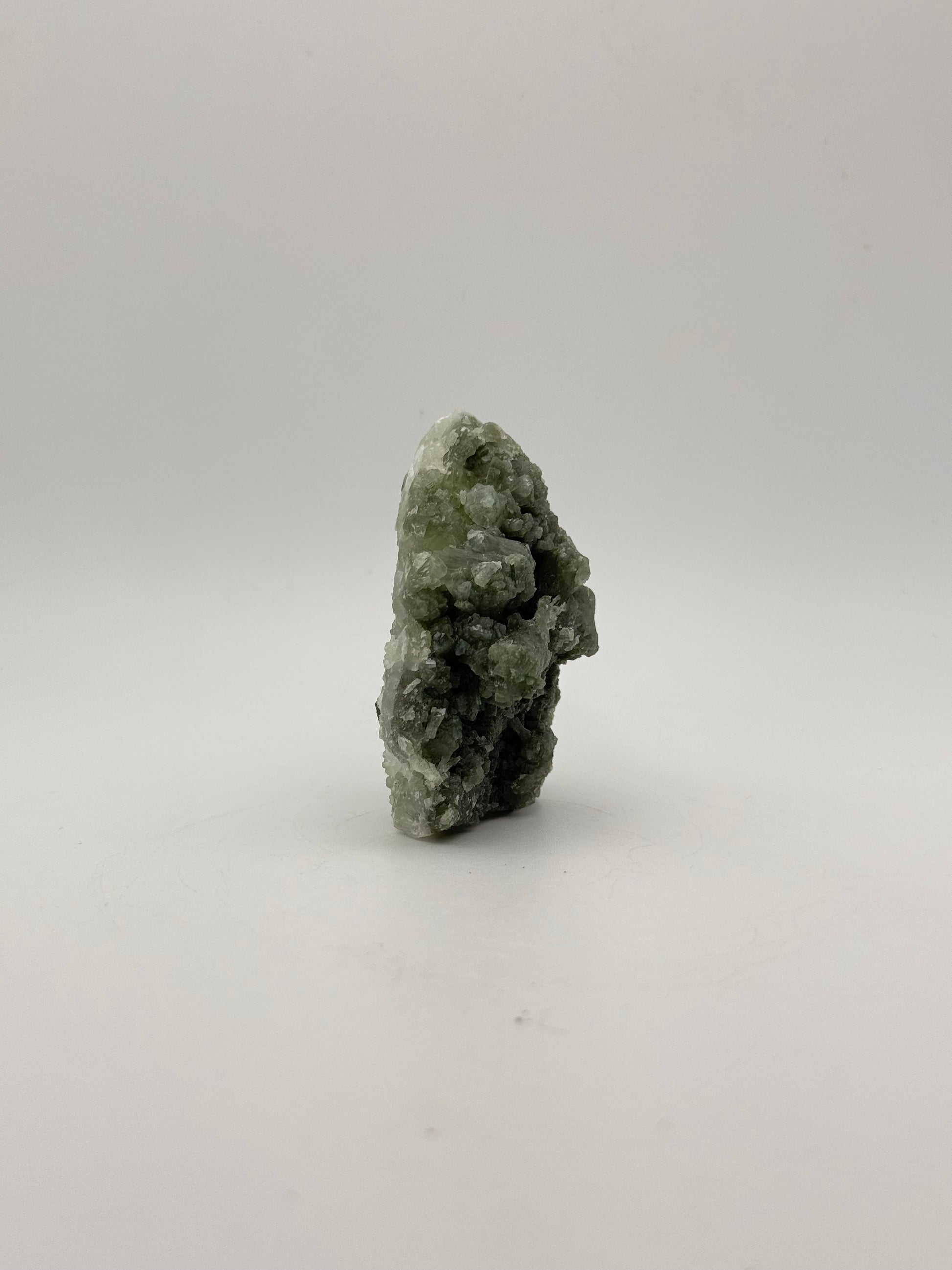 Raw Prehnite specimen with amazing green color.