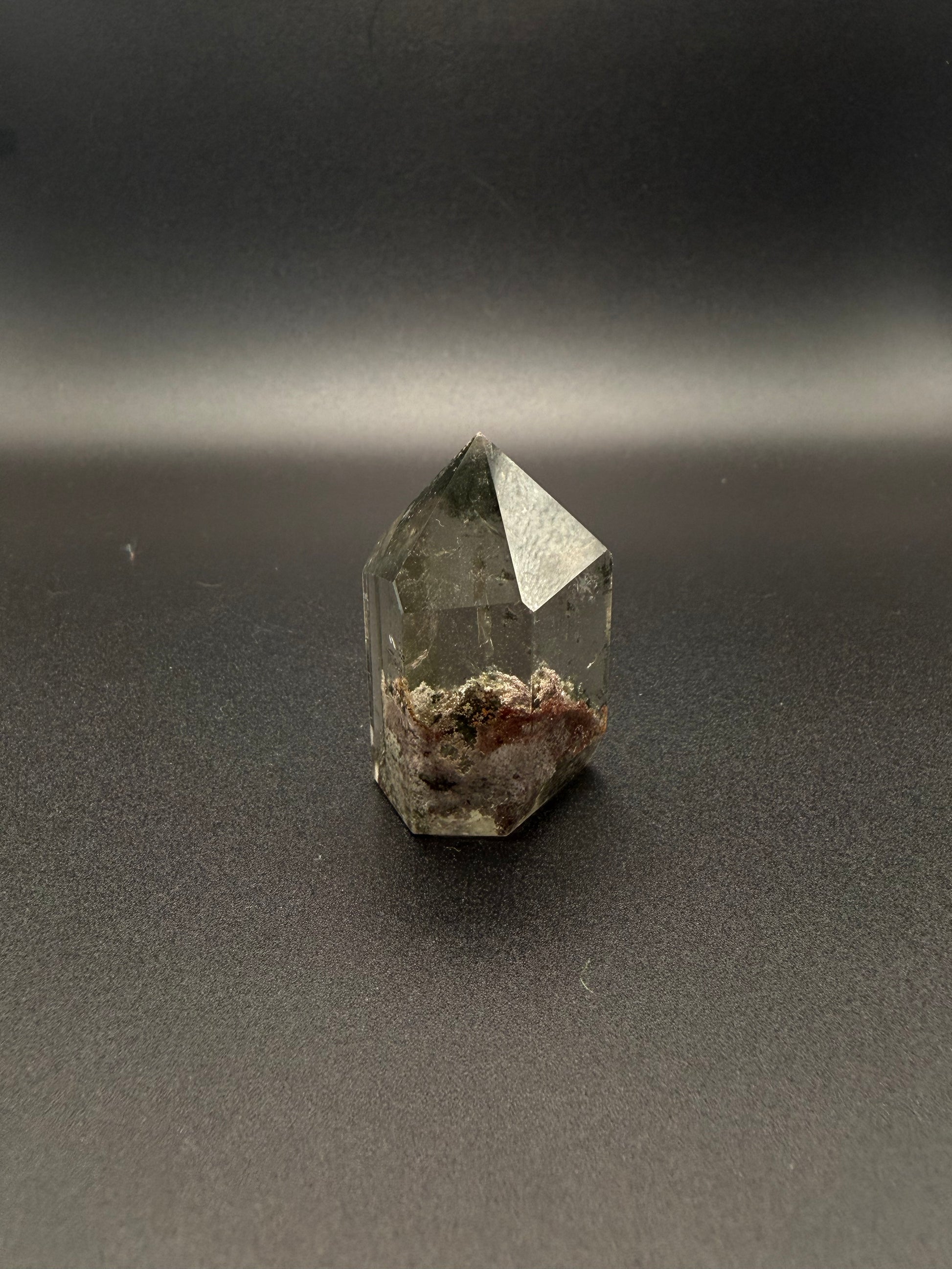 Polished garden quartz crystal tower with six sides.