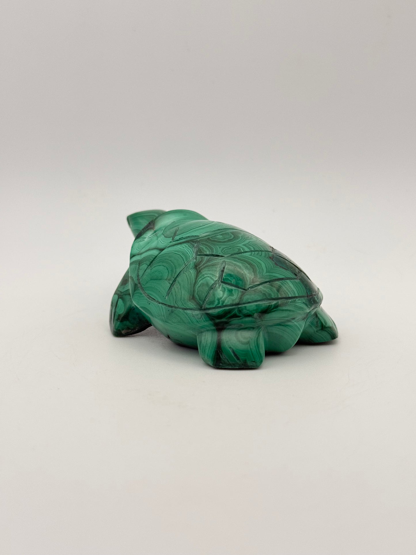 Vibrant green malachite stone carving of a turtle.