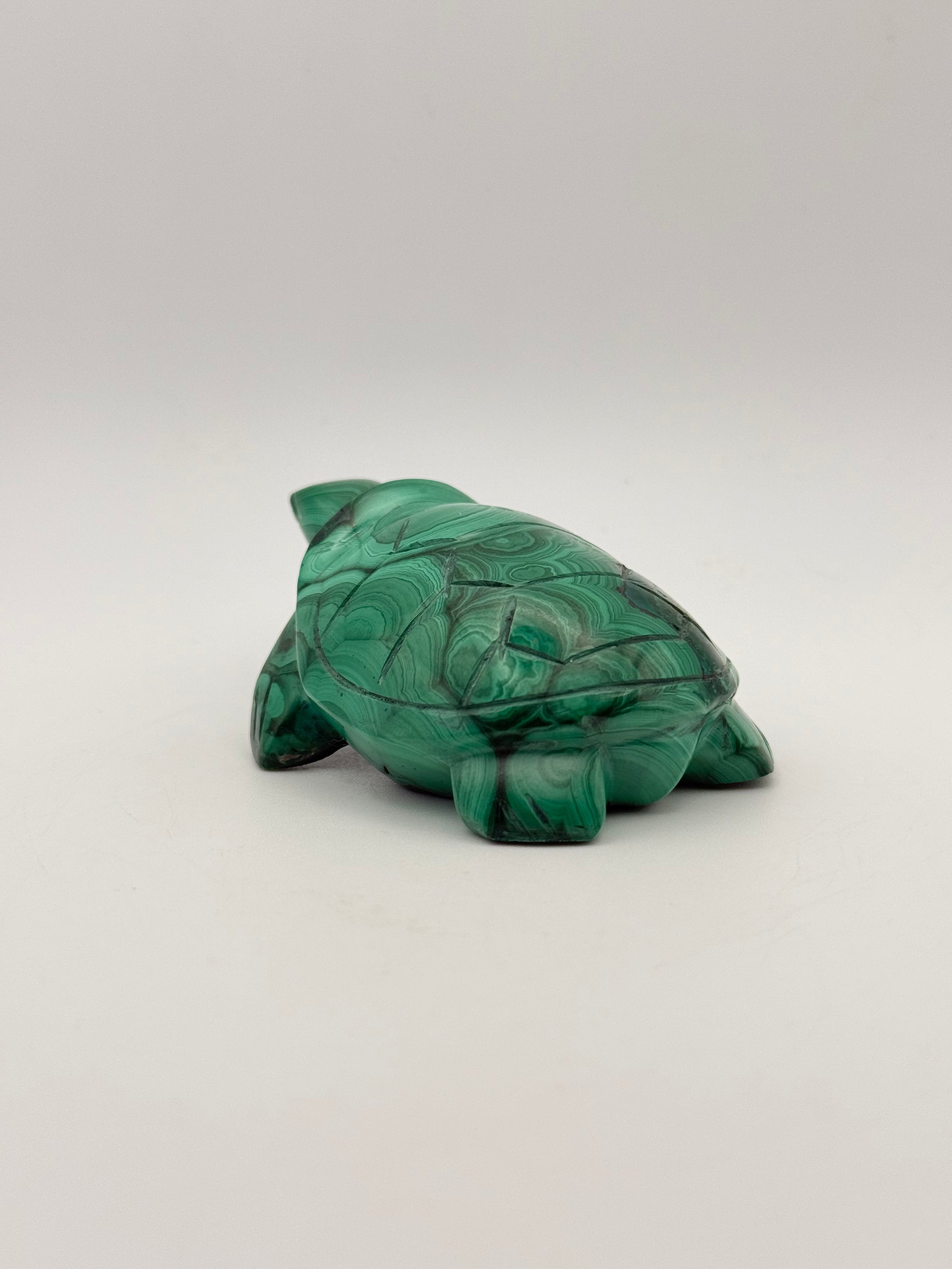 Vibrant green malachite stone carving of a turtle.