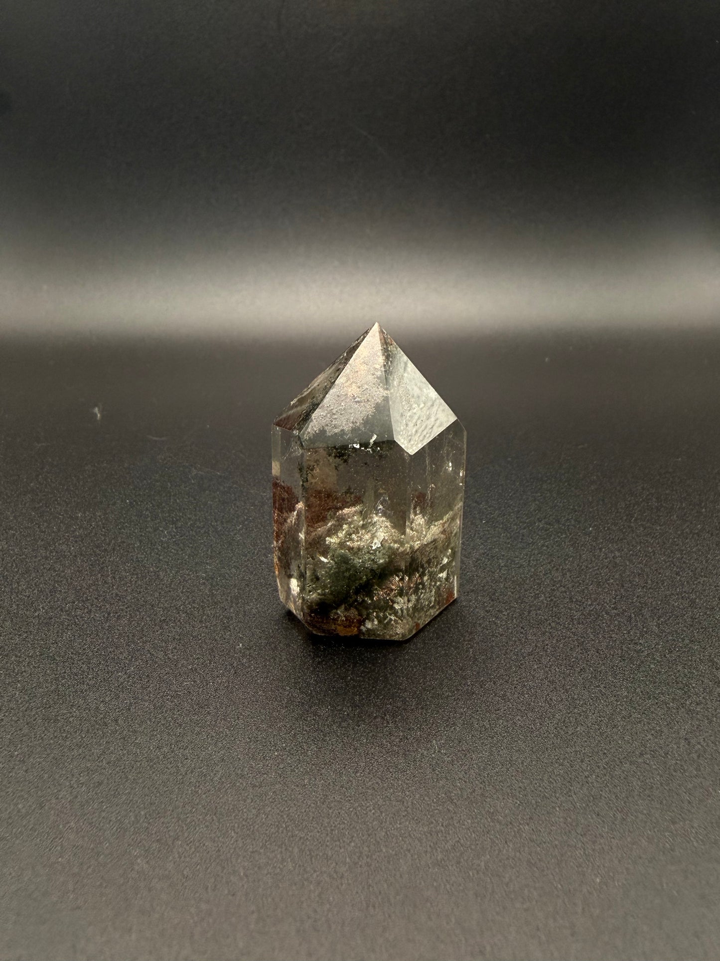 Polished garden quartz crystal tower with six sides.