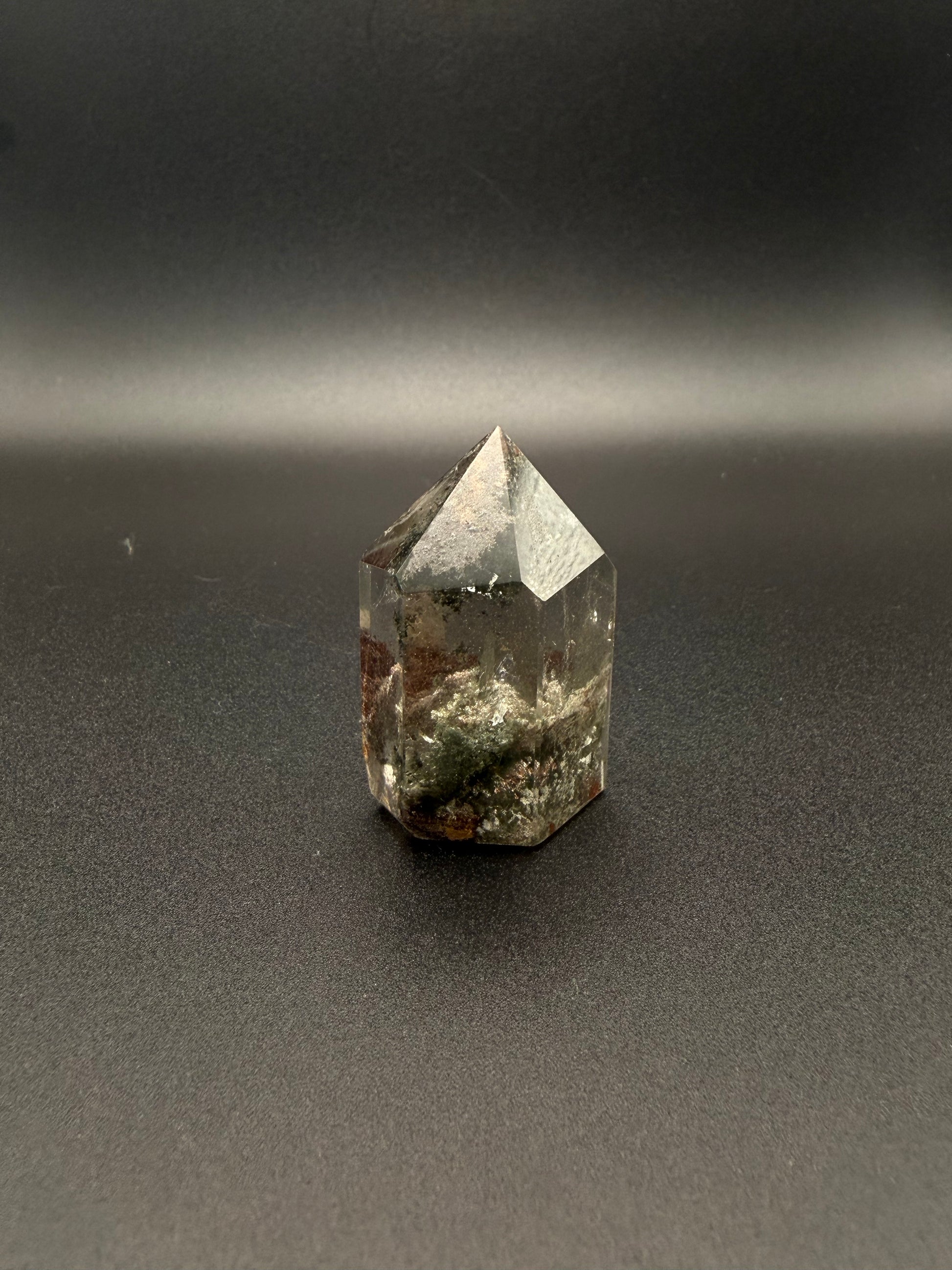 Polished garden quartz crystal tower with six sides.