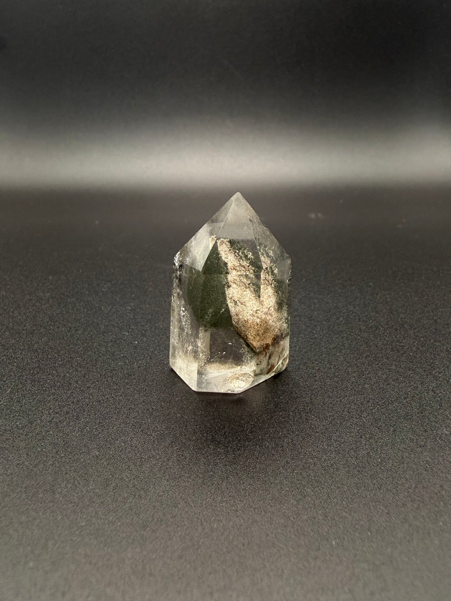 Polished garden quartz crystal tower with six sides.