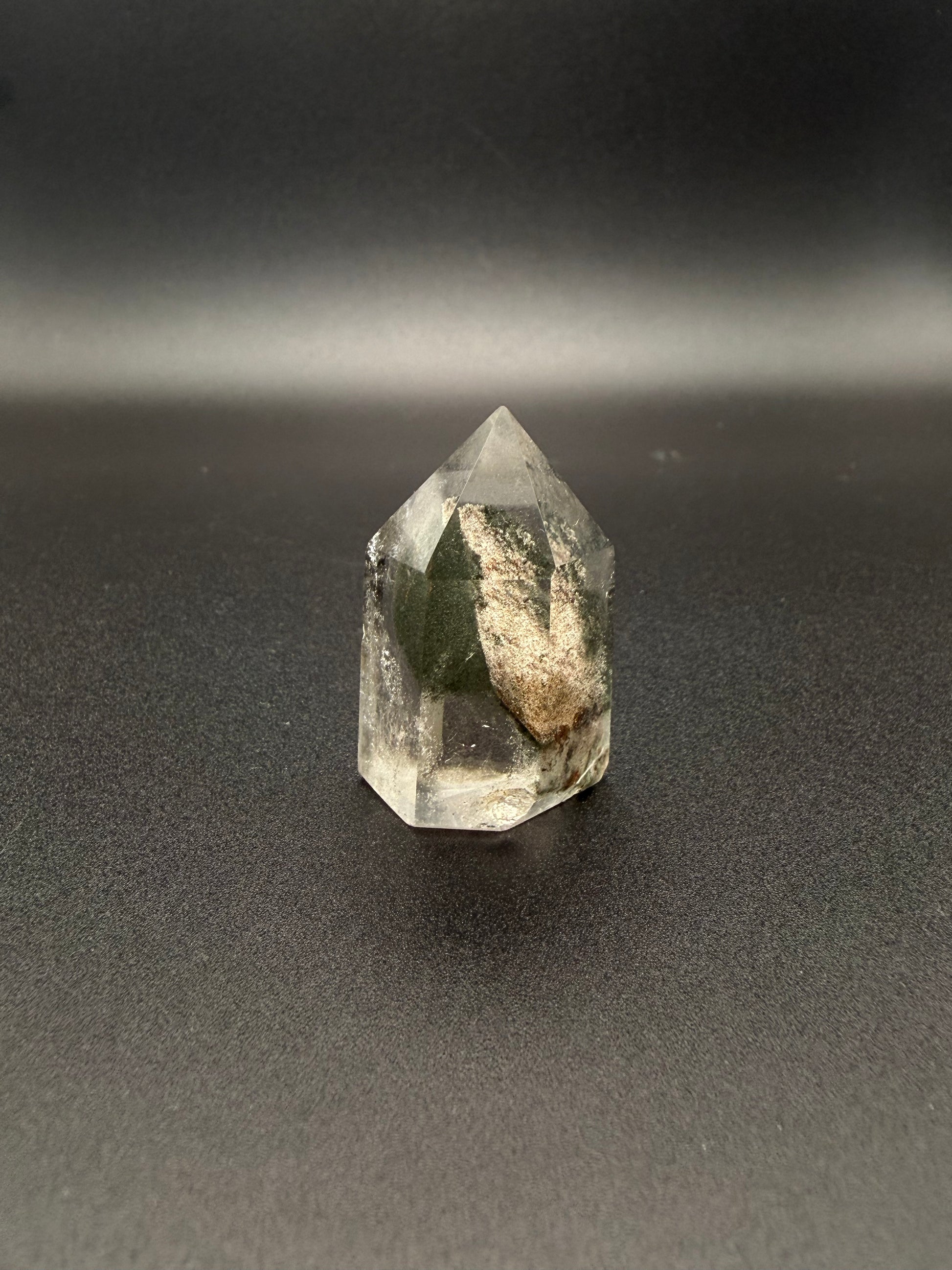 Polished garden quartz crystal tower with six sides.