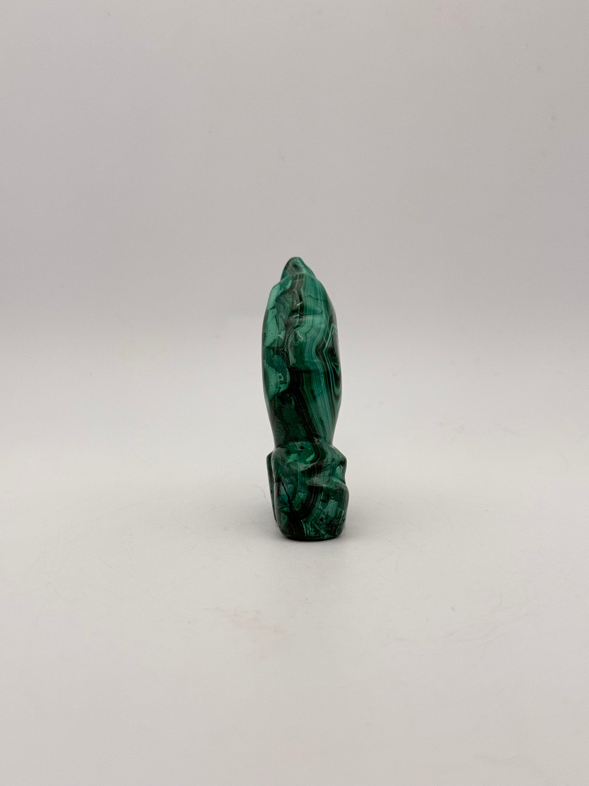 Polished malachite dolphin carving.
