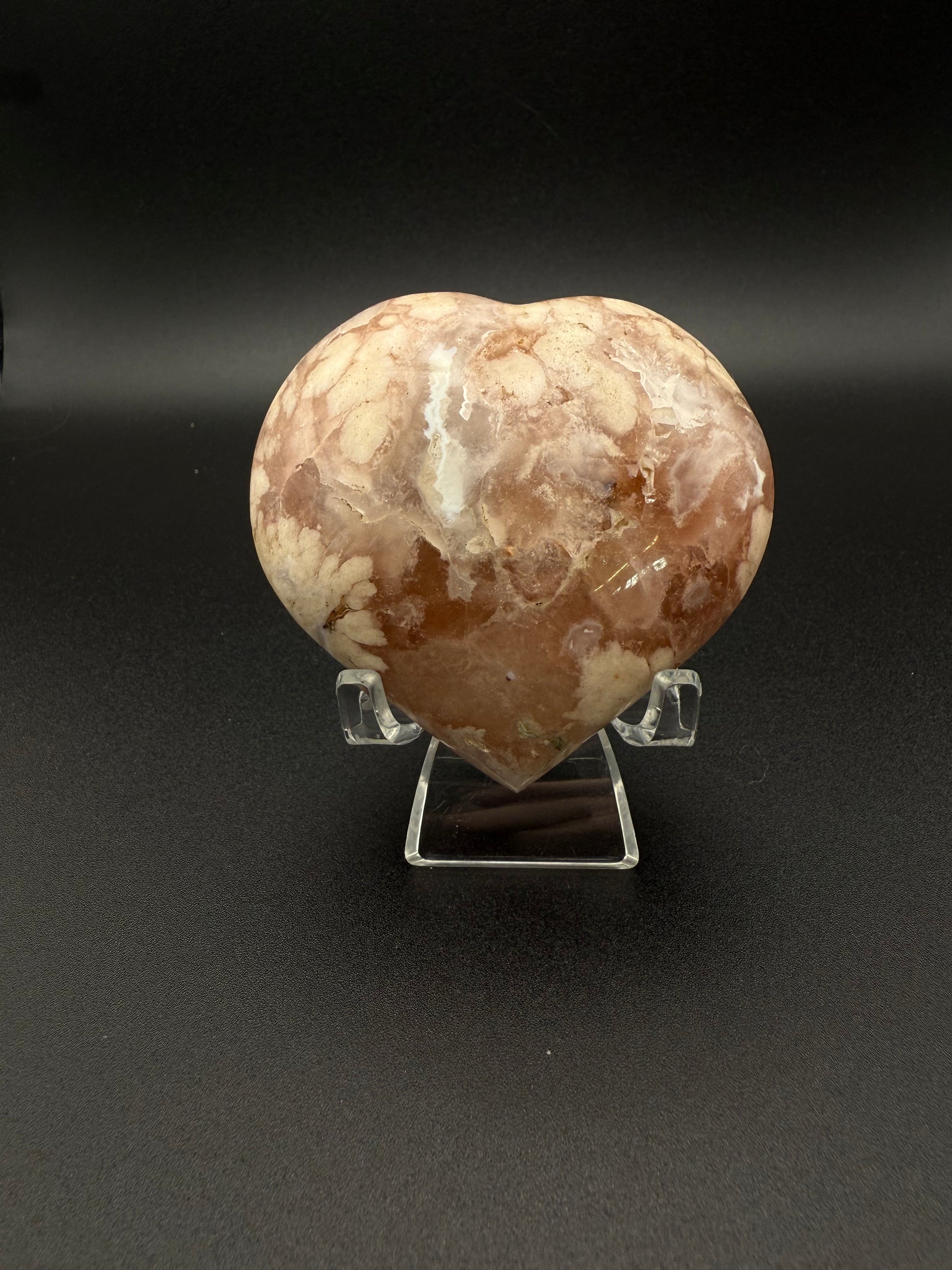 Flower agate polished crystal in the shape of a heart.