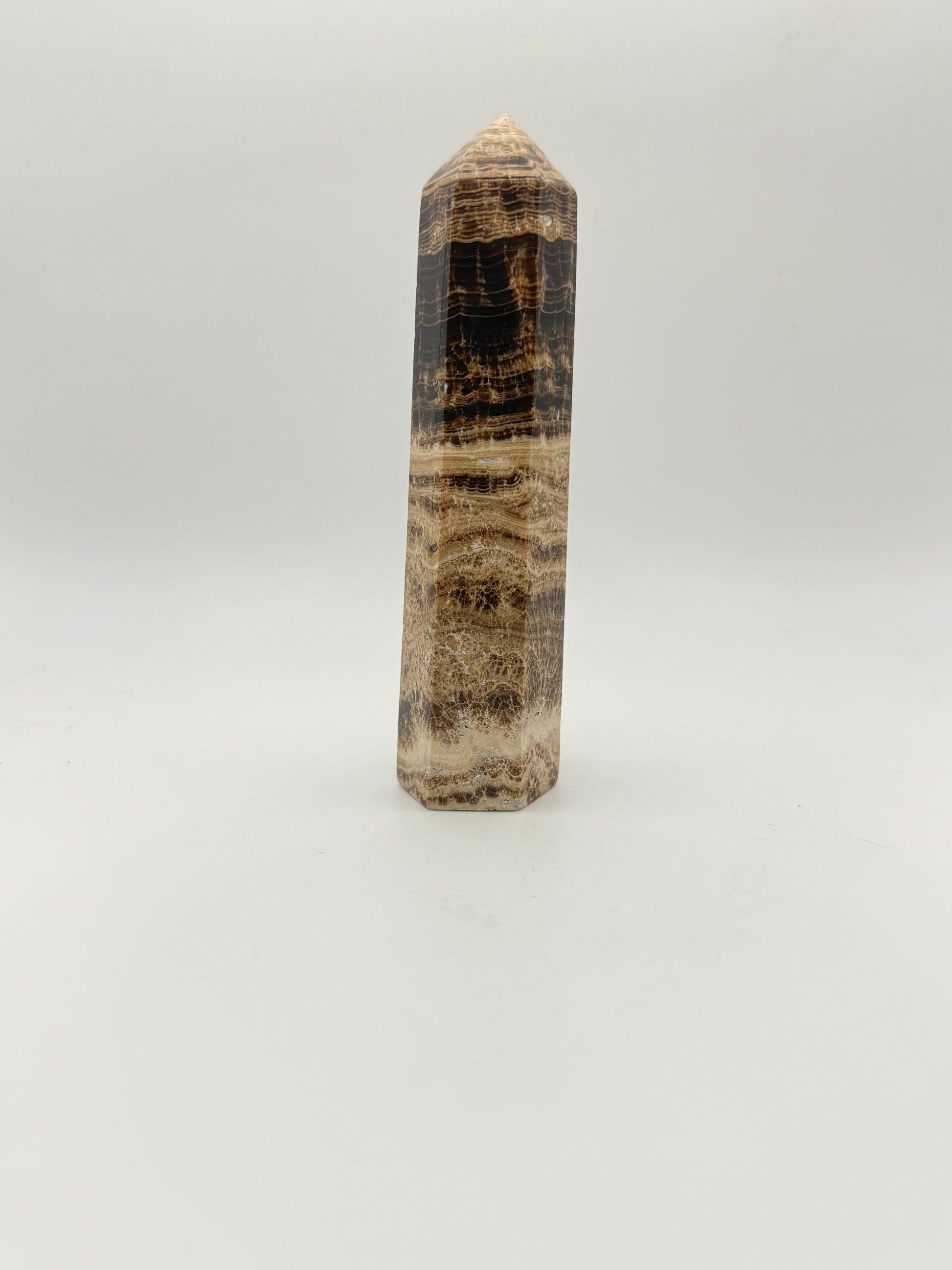 Polished chocolate calcite crystal tower. about 5 inches tall.