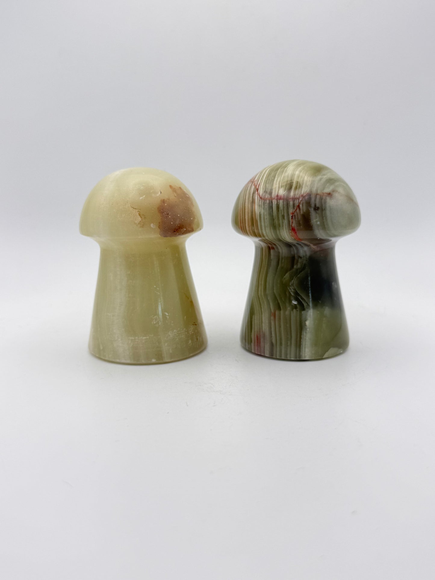 Two onyx mushroom-shaped stones.