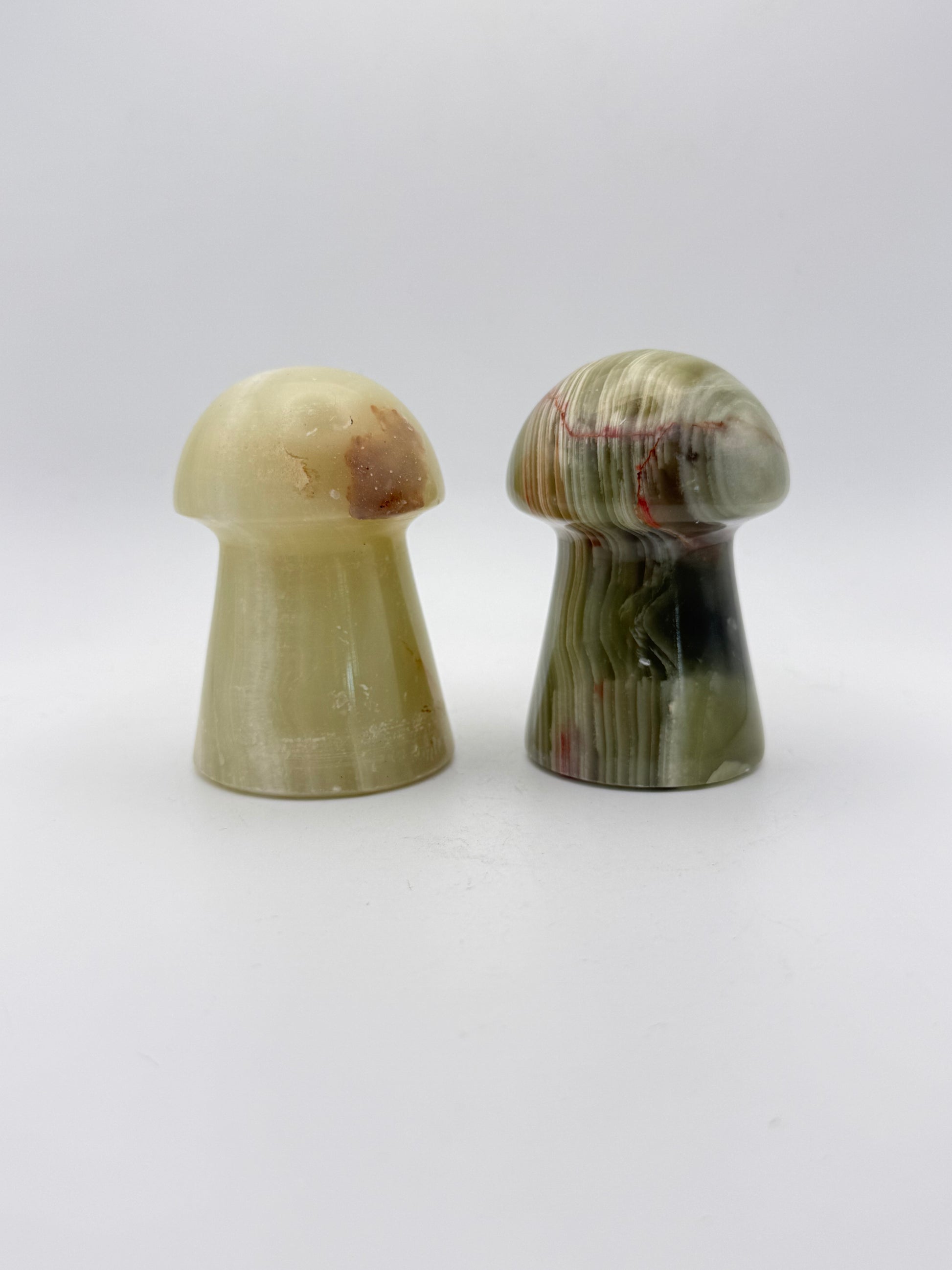 Two onyx mushroom-shaped stones.