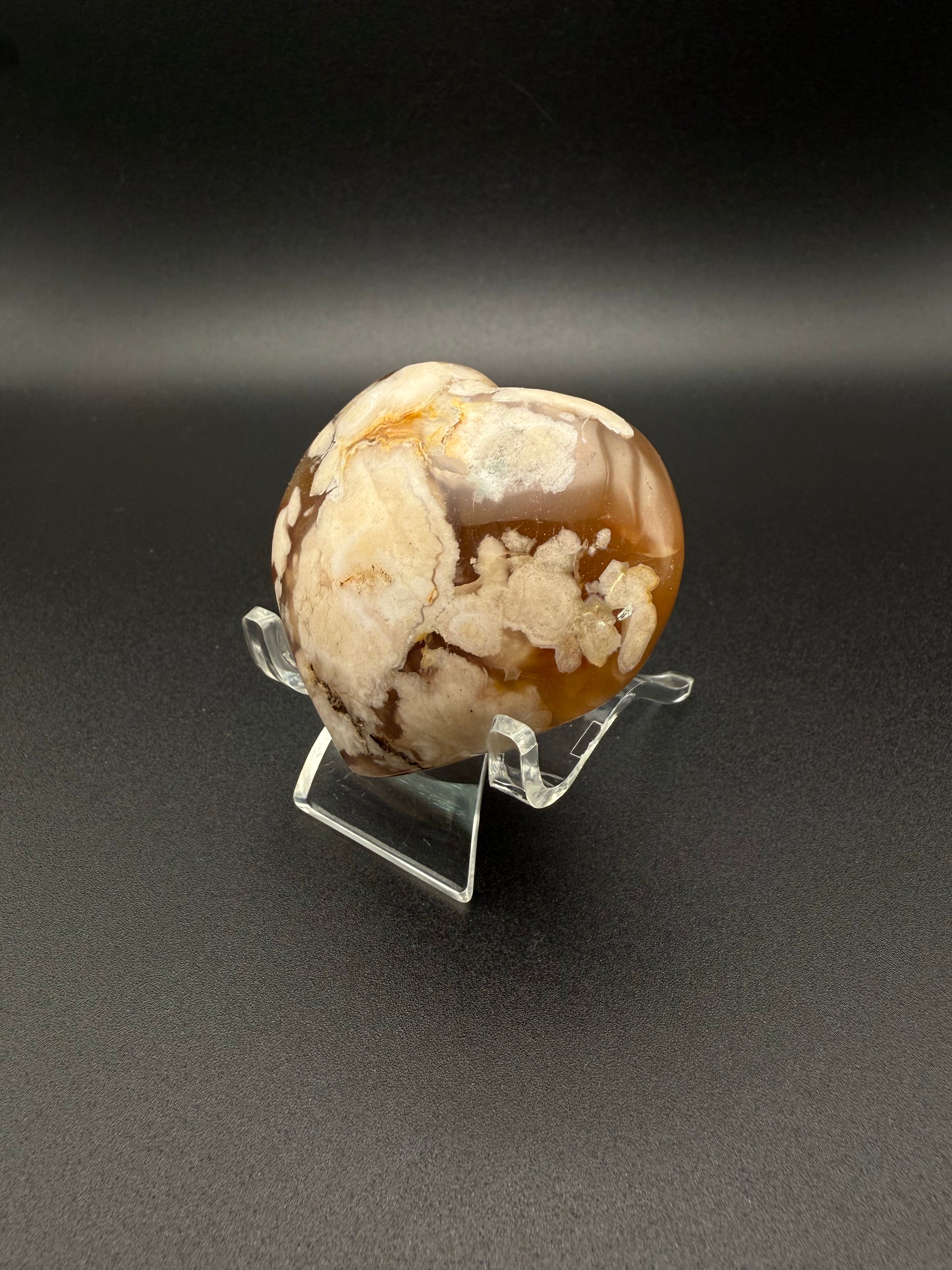 Flower Agate polished crystal in the shape of a heart.
