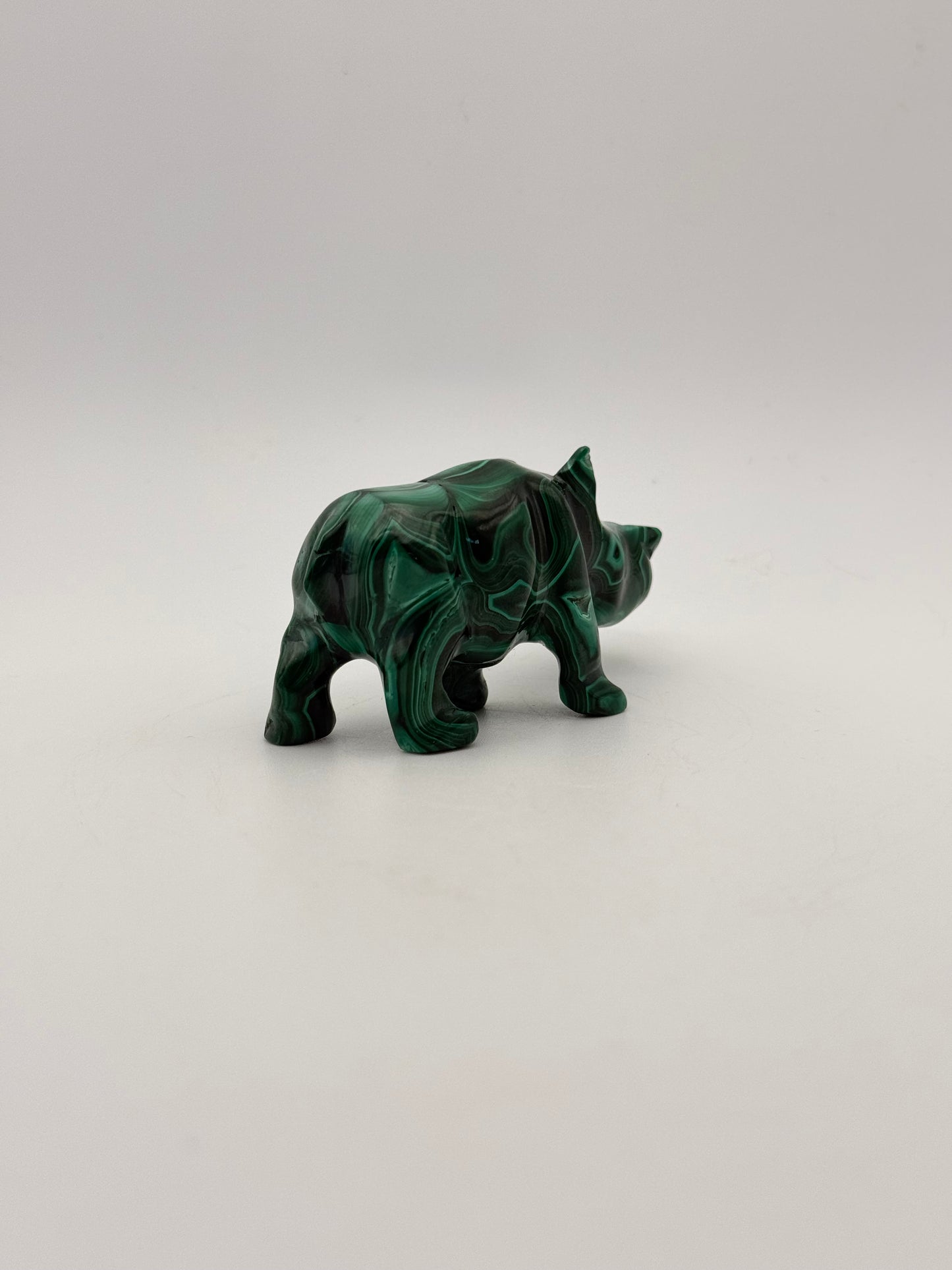 Vibrant green malachite stone carving of a rhino.