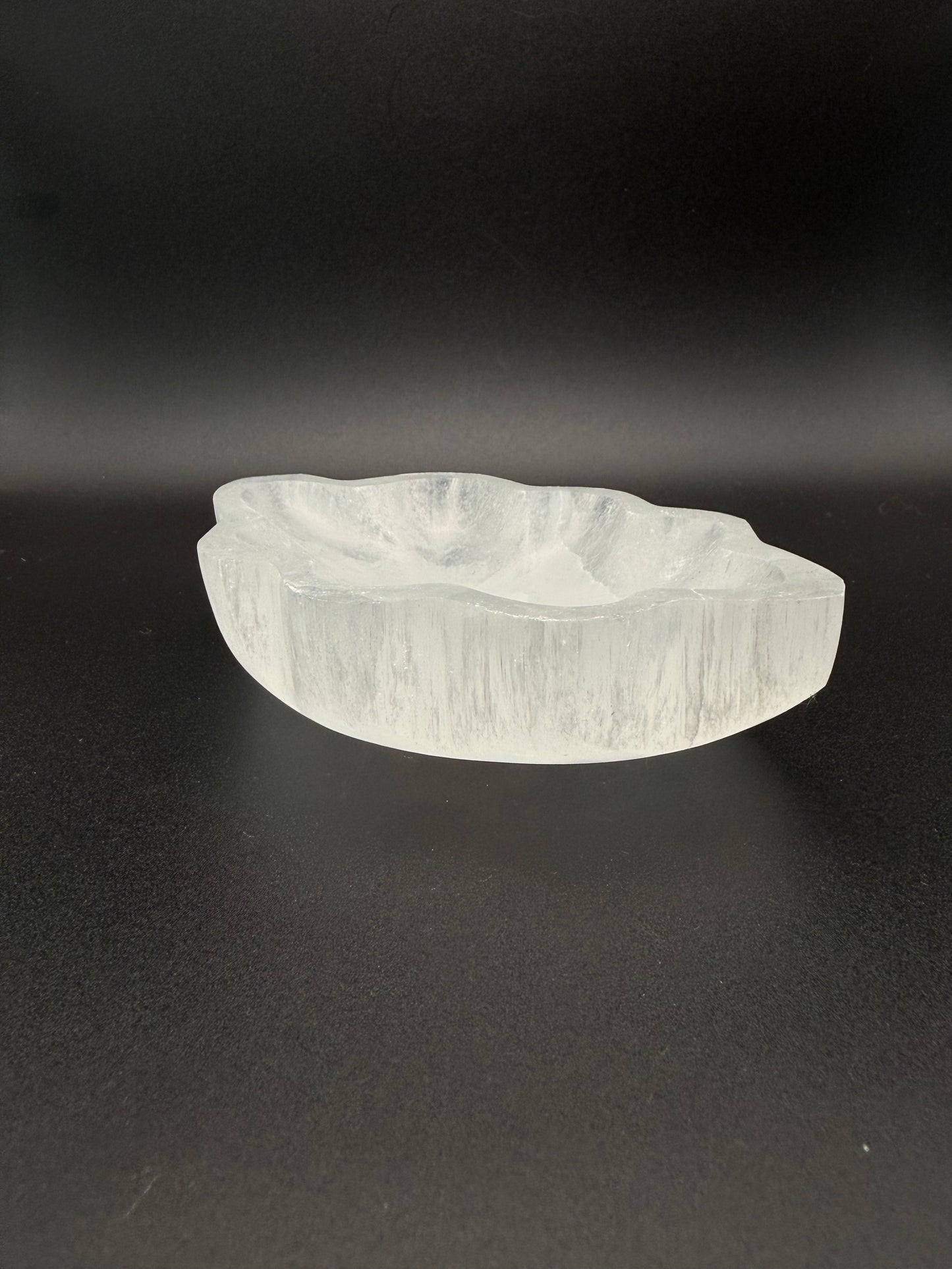 Selenite bowl in the shape of a leaf.
