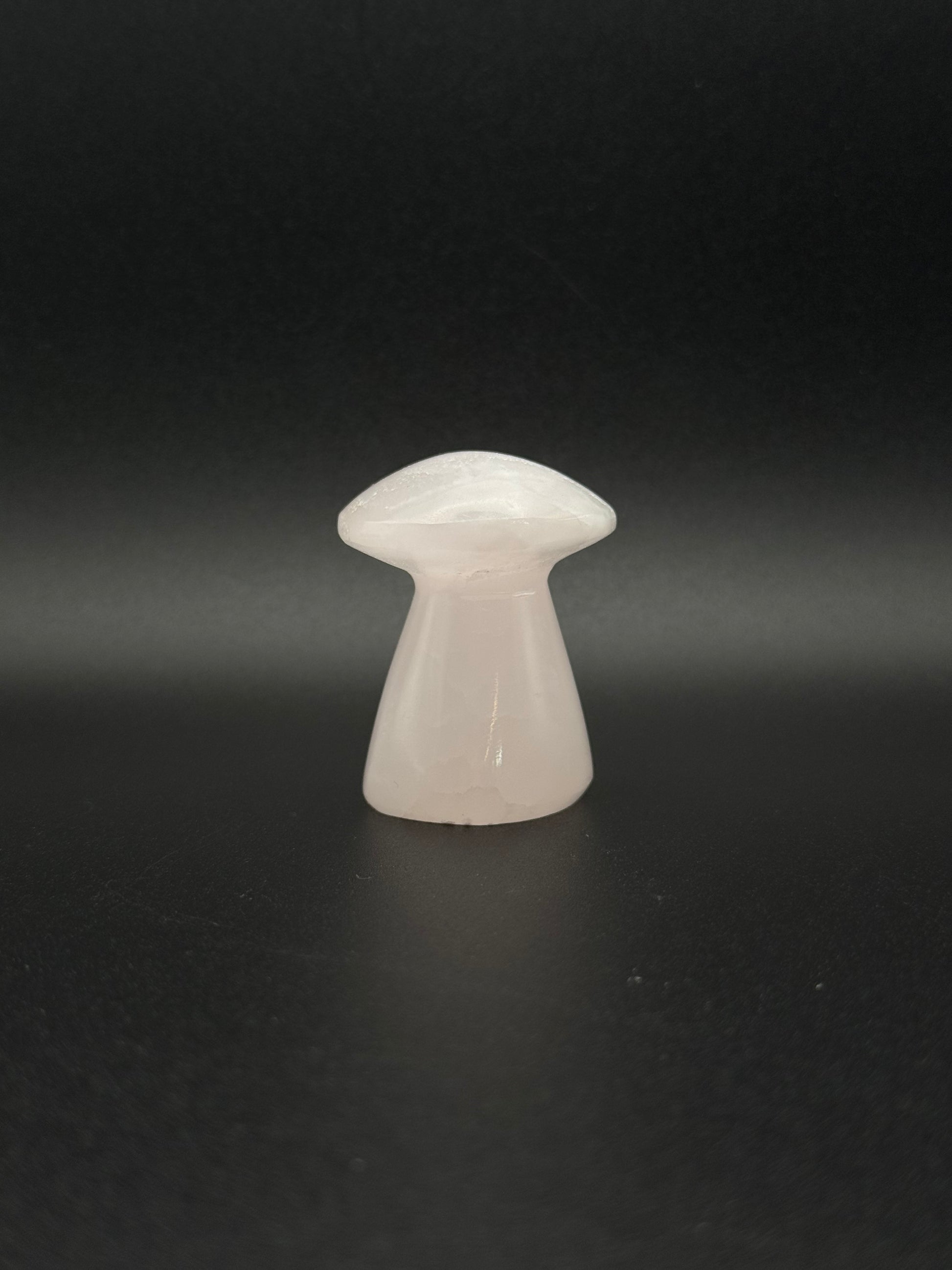Polished pink calcite mushroom. Pink calcite glows under uv light.