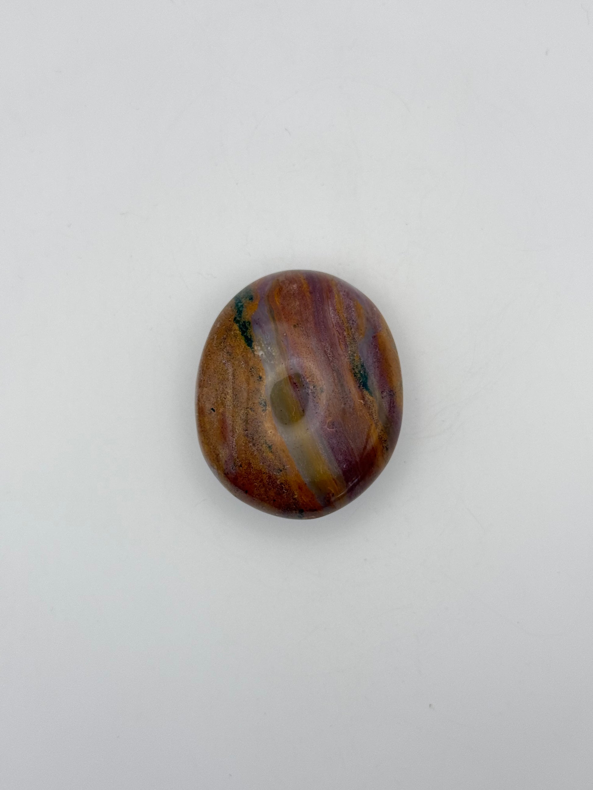 Polished ocean jasper palm stone.