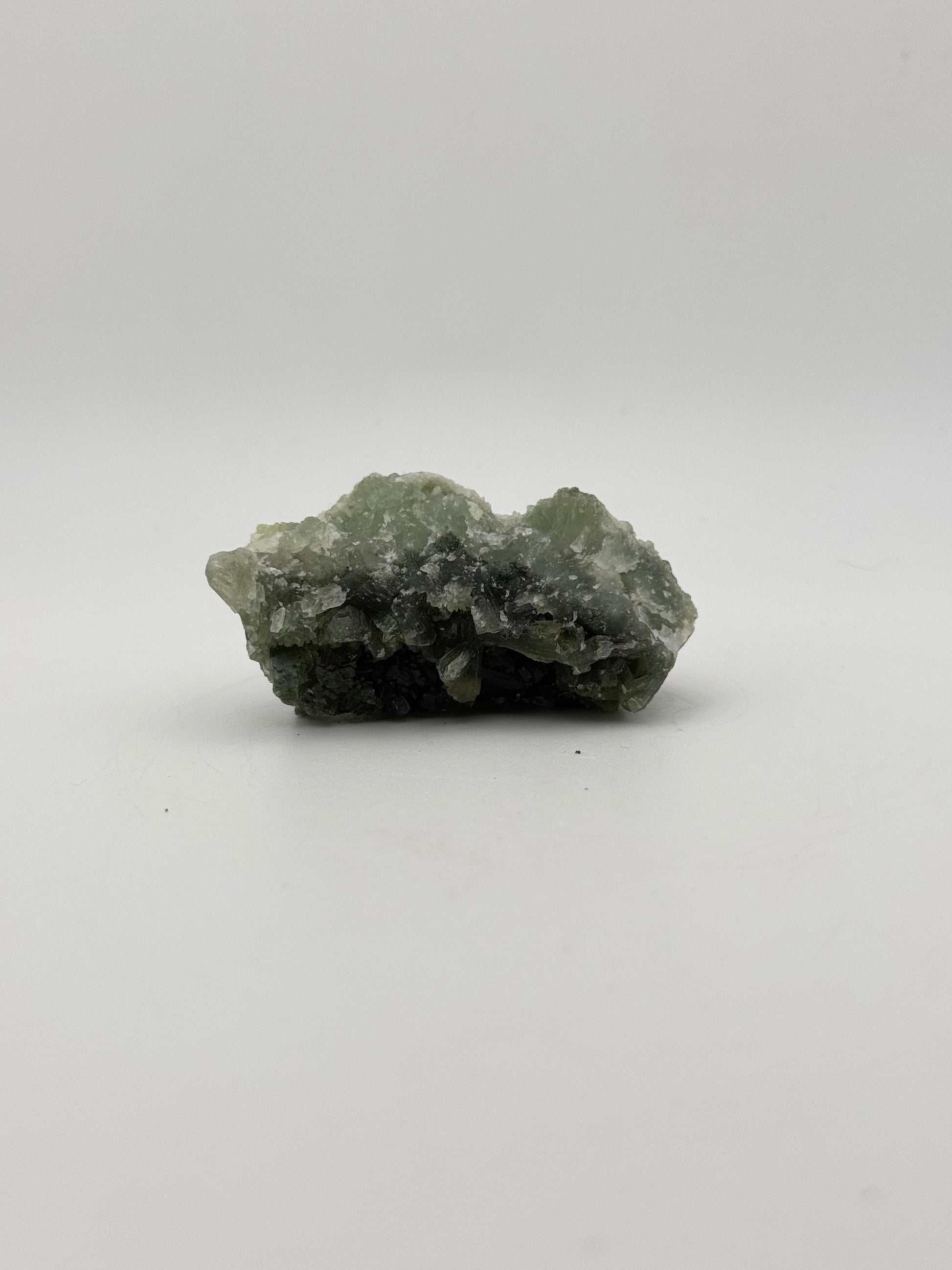 Raw Prehnite specimen with amazing green color.