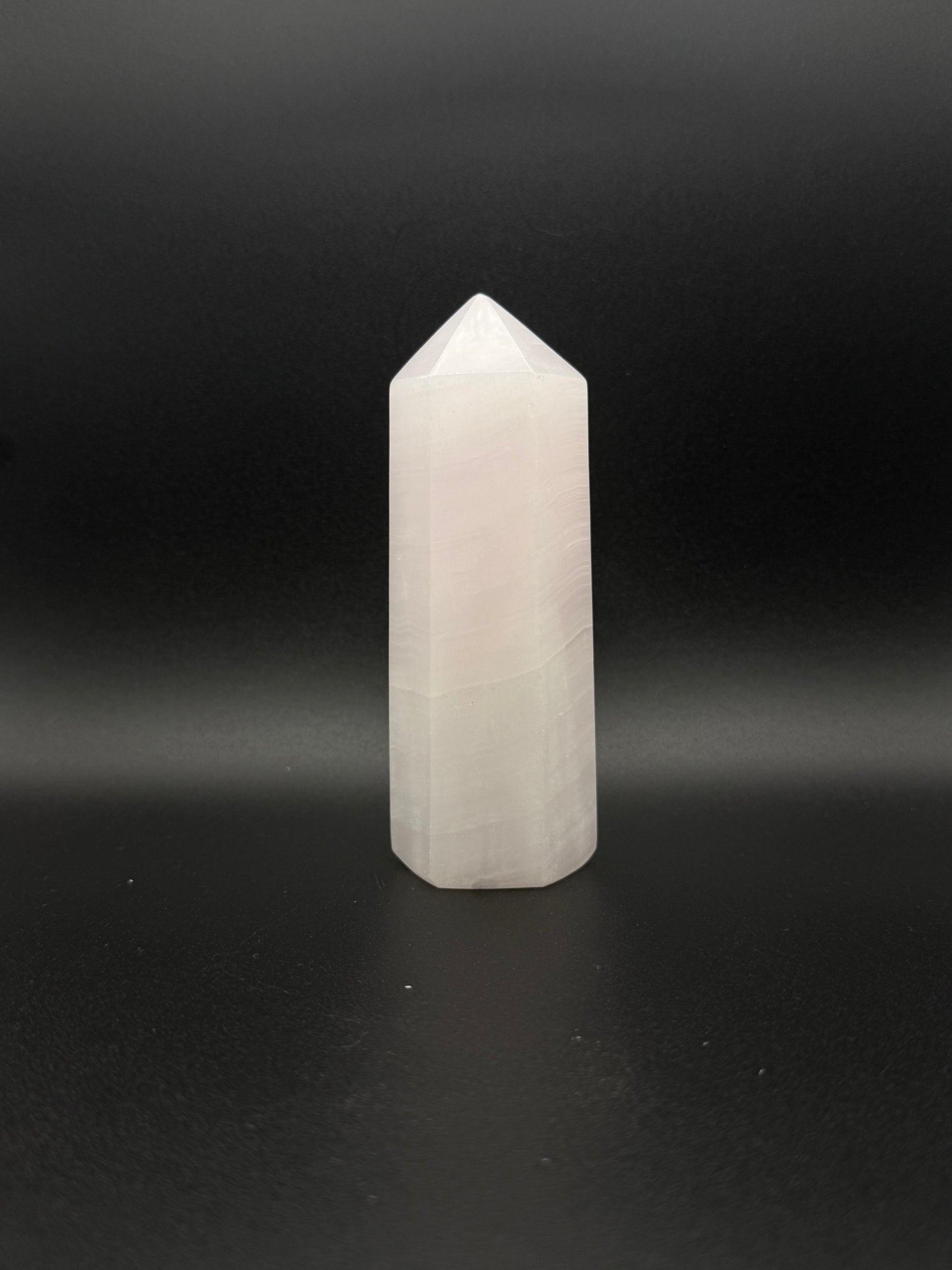 Polished pink calcite tower. Pink calcite glows under uv light.