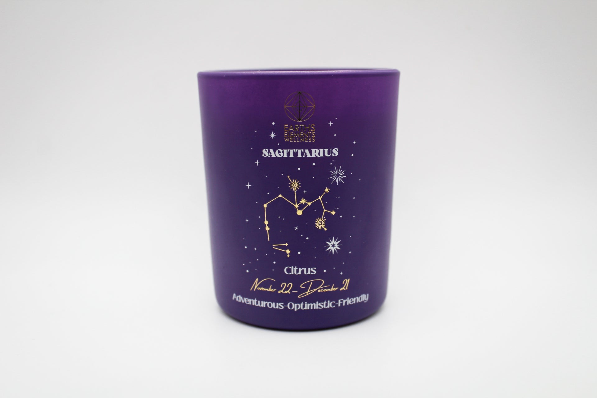 A purple candle with a Sagittarius sign design, featuring a centaur, stars, and a crescent moon.