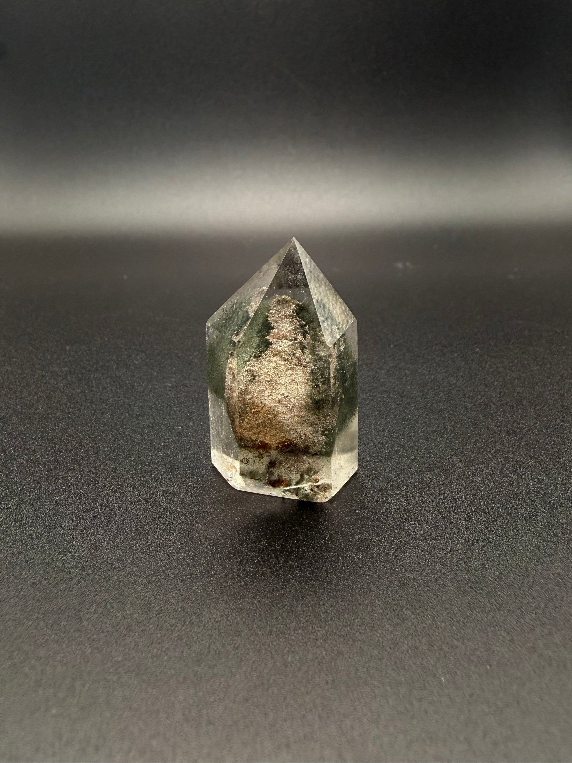 Polished garden quartz crystal tower with six sides.